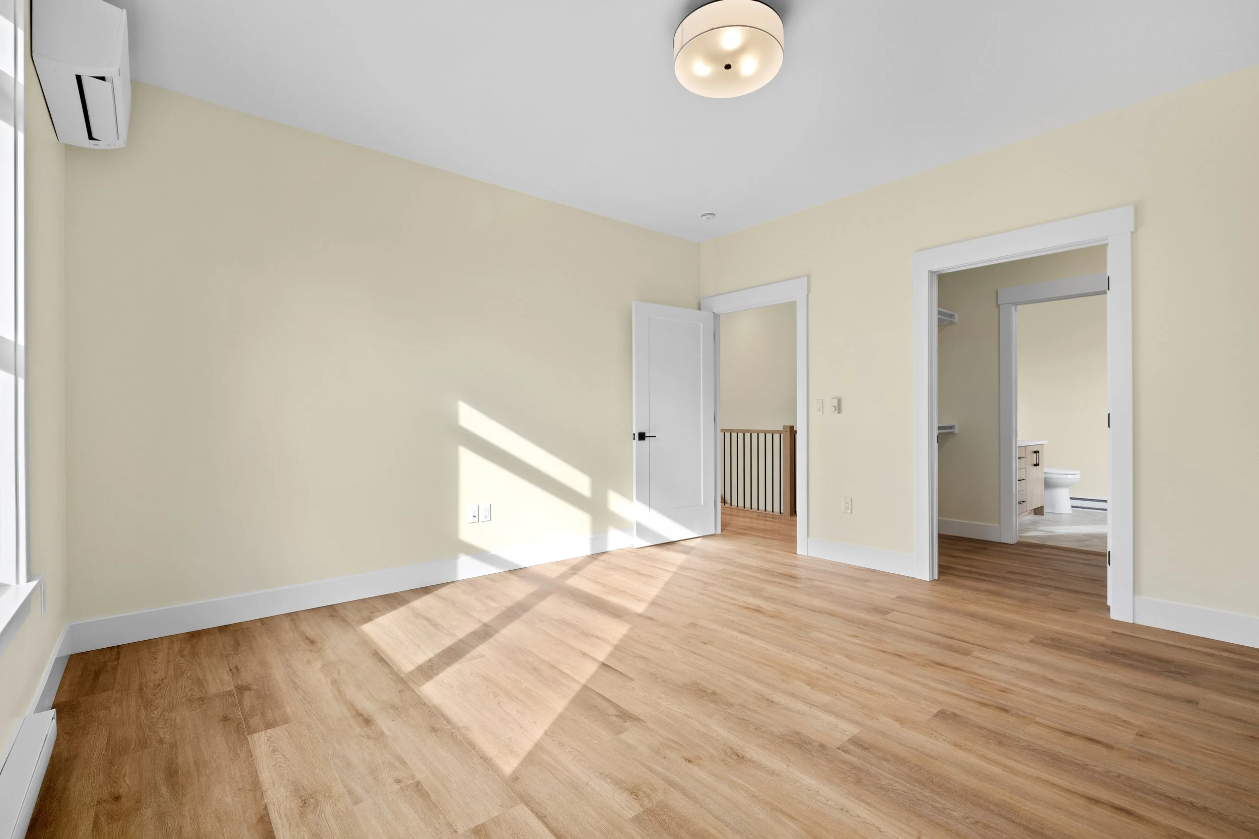 Large primary bedroom with attached ensuite and walk-in closet