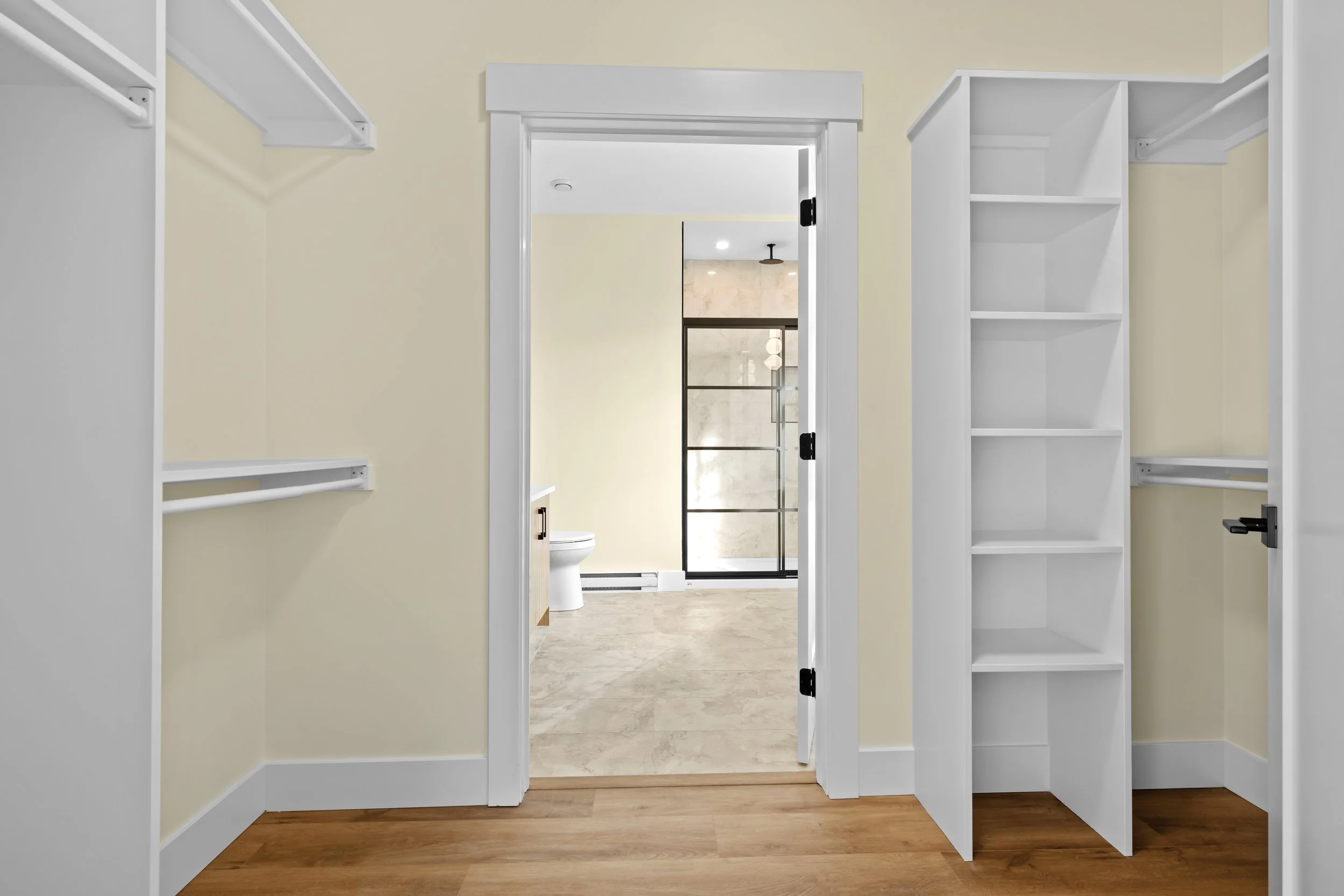 Sizeable walk in closet with custom built-in shelving