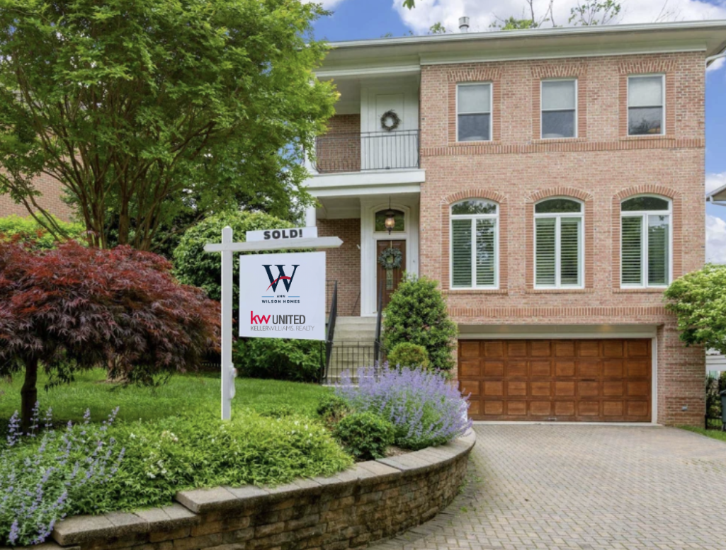 Ann Wilson Homes sold sign in front of beautiful Arlington, VA home for sale with a new banner saying 'SOLD!' across the sign.