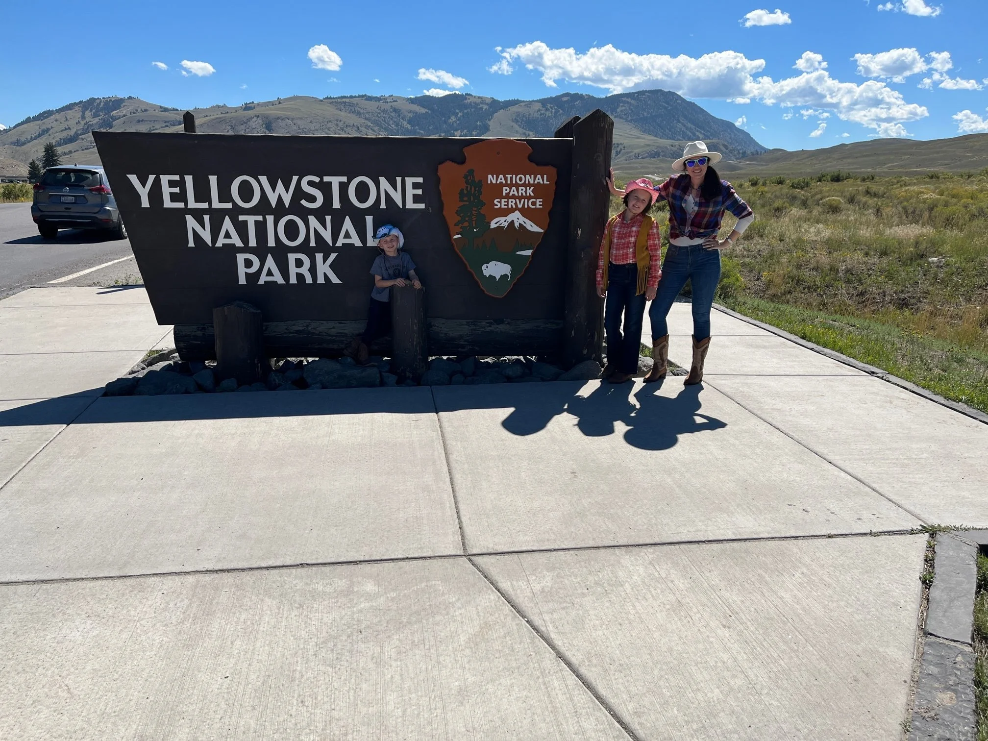 The author and her kids at the Gardiner entrance to Yellowstone National Park