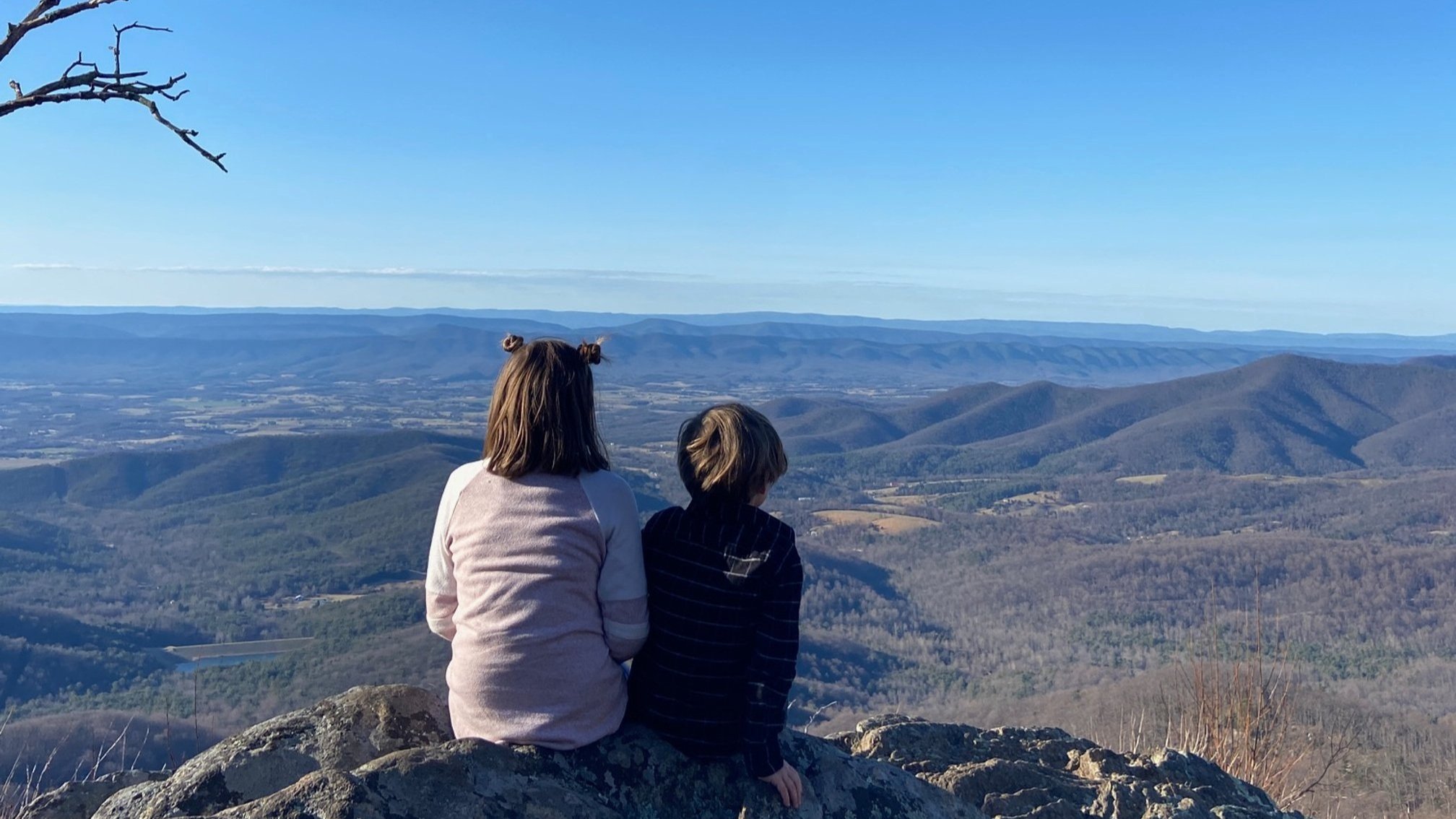 The author's children sit on a rock at Jewell Hollow Overlook in Shenandoah National Park