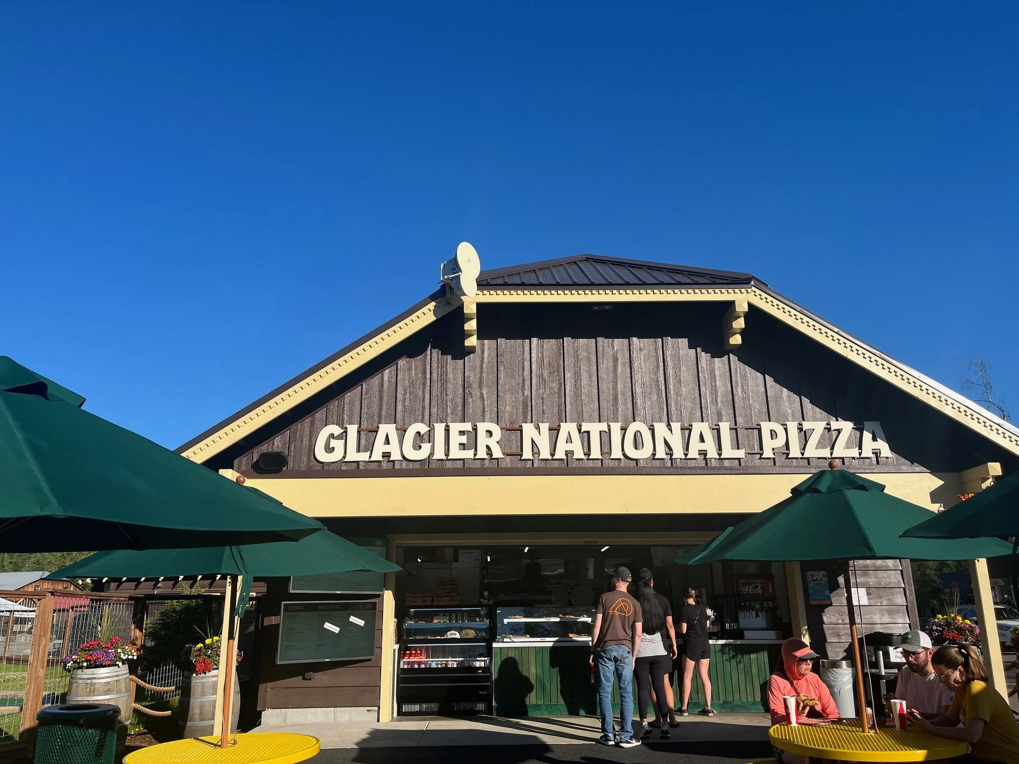 The exterior and seating area of Glacier National Pizza