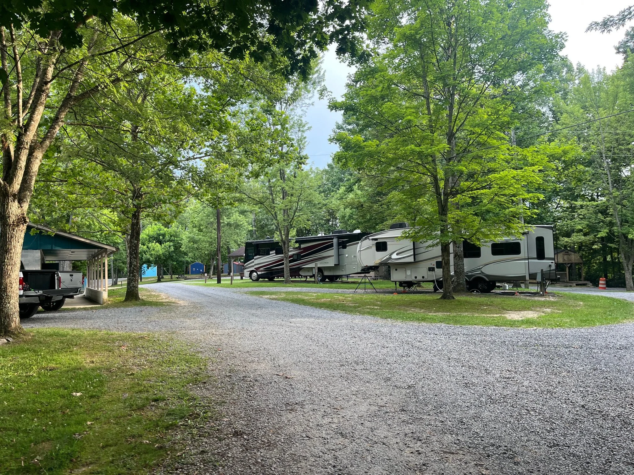 RVs parked at sites in the main loop of Rifrafters Campground near the bath house