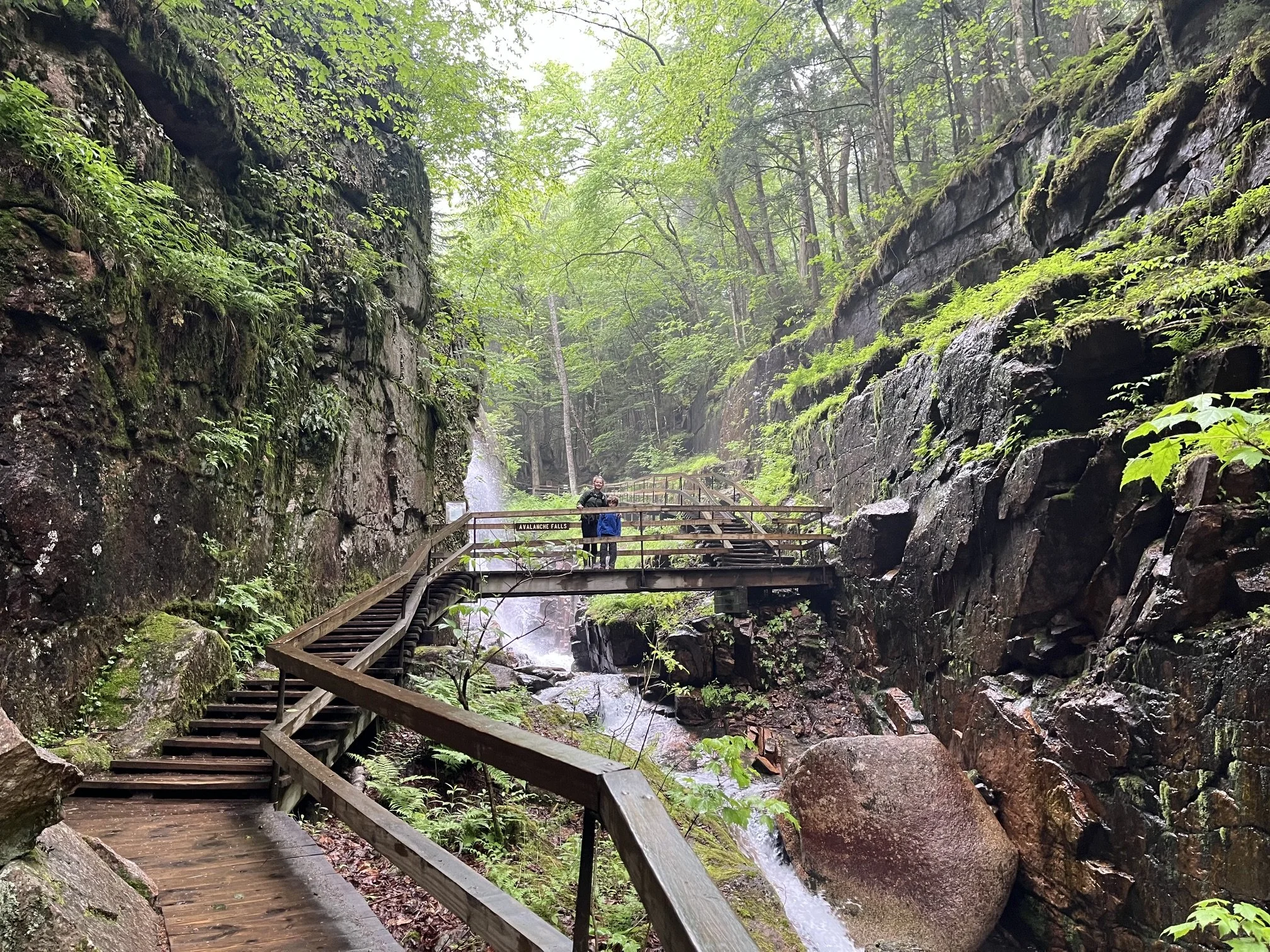The author's children stand on a wooden bridge in Flume Gorge at New Hampshire's Franconia Notch State Park
