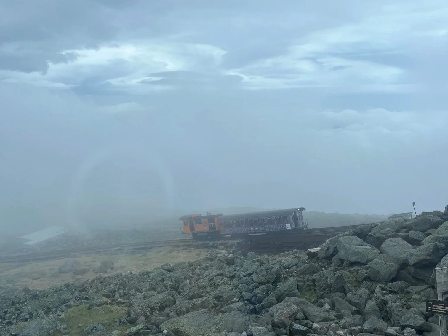 One of the Mt. Washington Cog Railway trains on the track in the fog