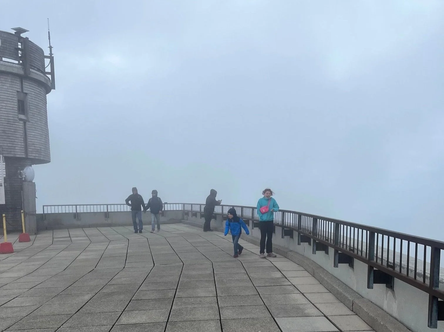 The author's children standing on the observation deck at Mt. Washington with fog surrounding them