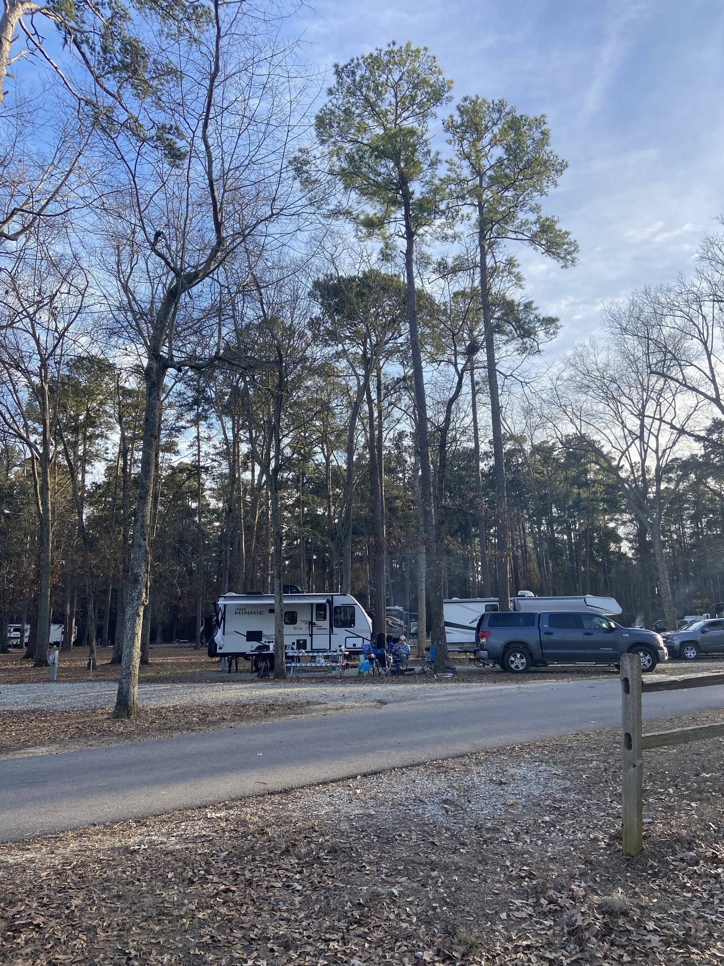 Winnebago travel trailer in camping spot at Santee State Park in South Carolina