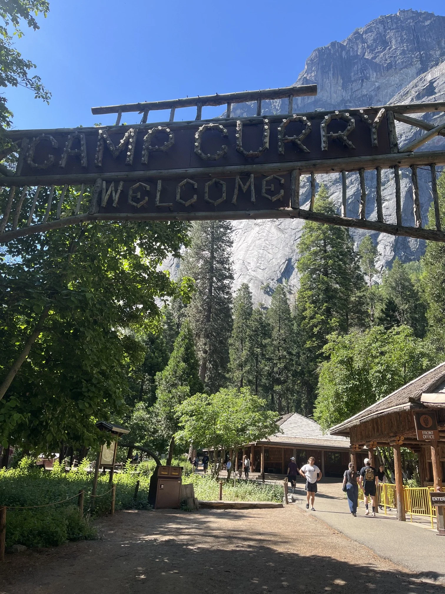 Rustic wooden Camp Curry welcome sign near the registration desk