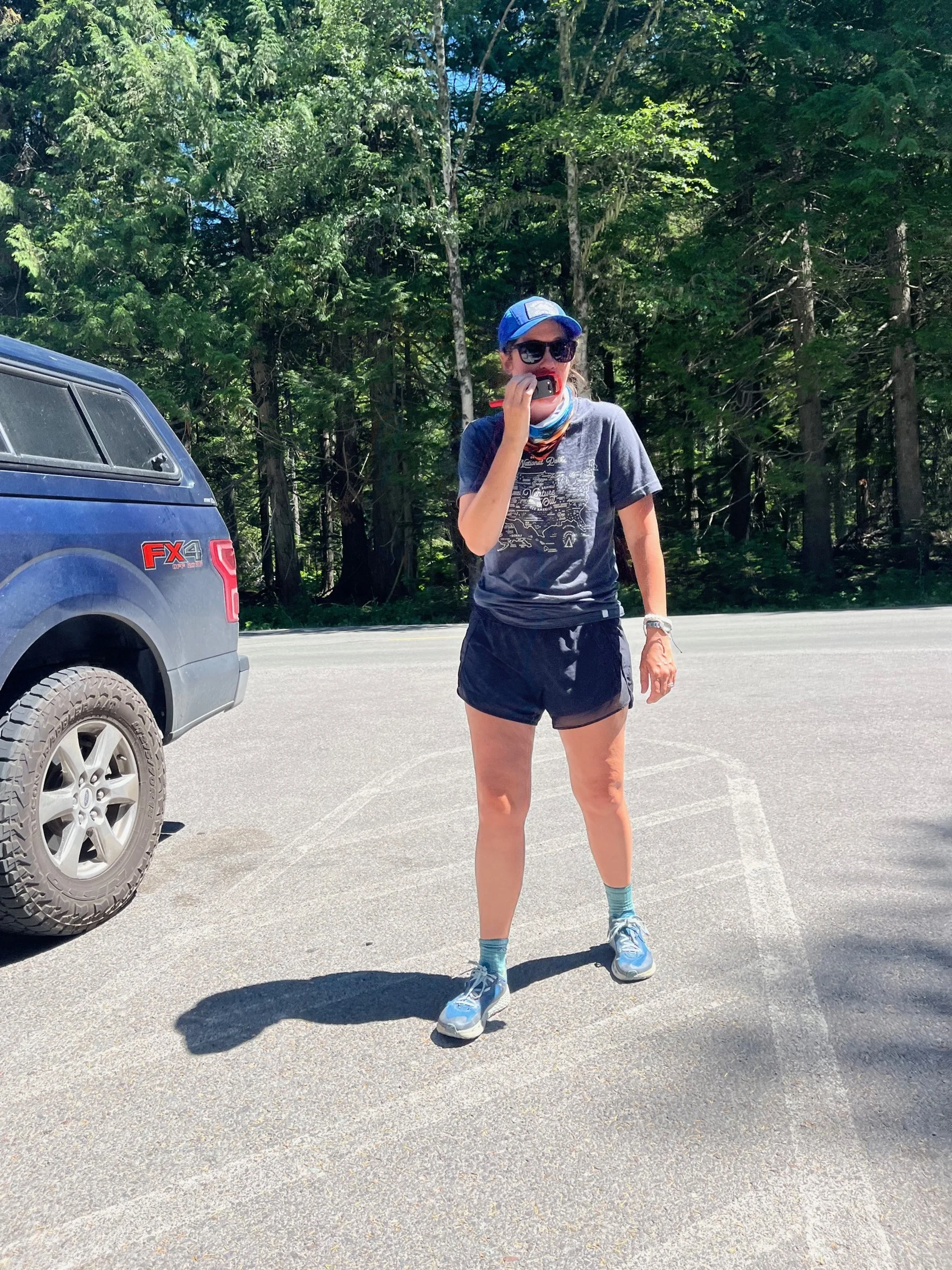 The author in a blue hat using a walkie talkie