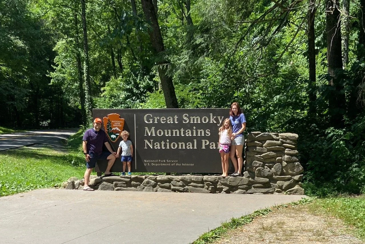 The author and her family stand beside the entrance sign to Great Smoky Mountains National Park