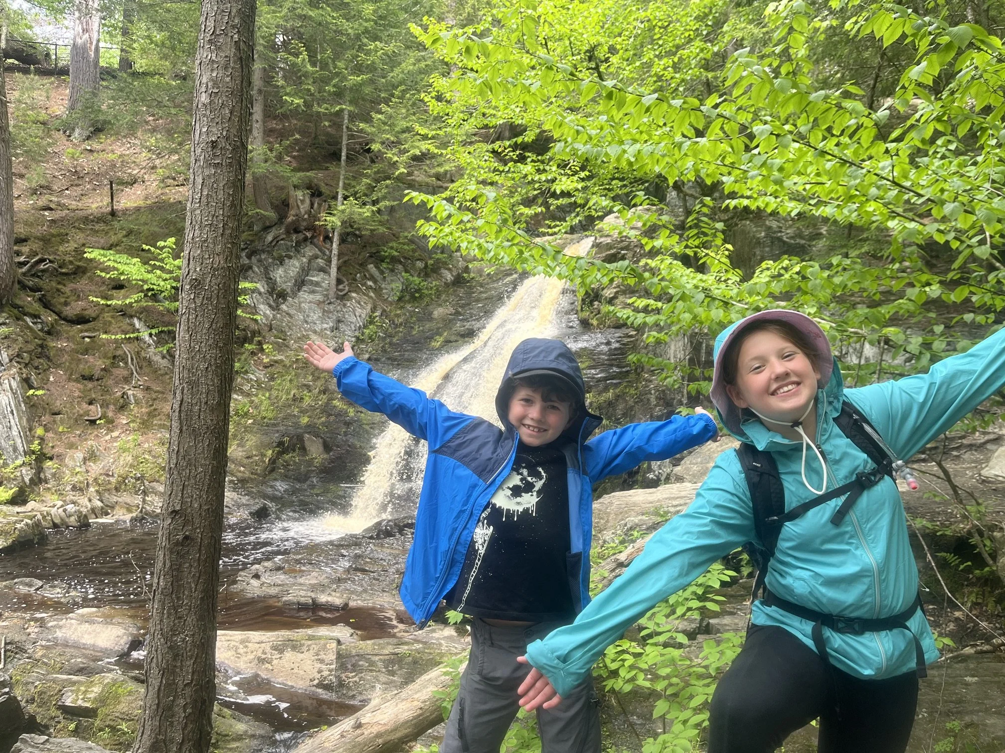 Two children standing in front of Cascade Falls in Saco, Maine