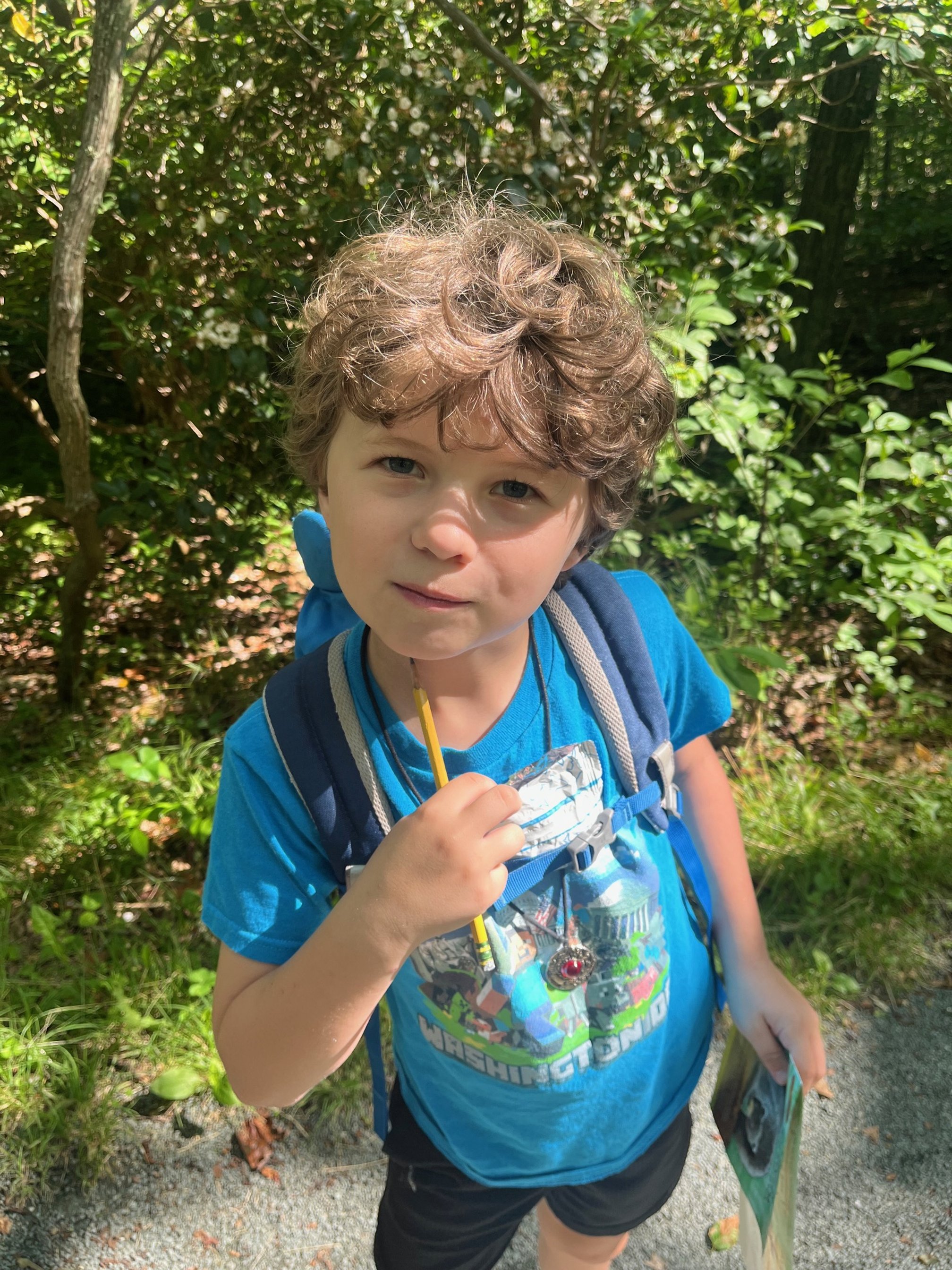 The author's young son carrying his trail snacks and pencil on the Limberlost Trail