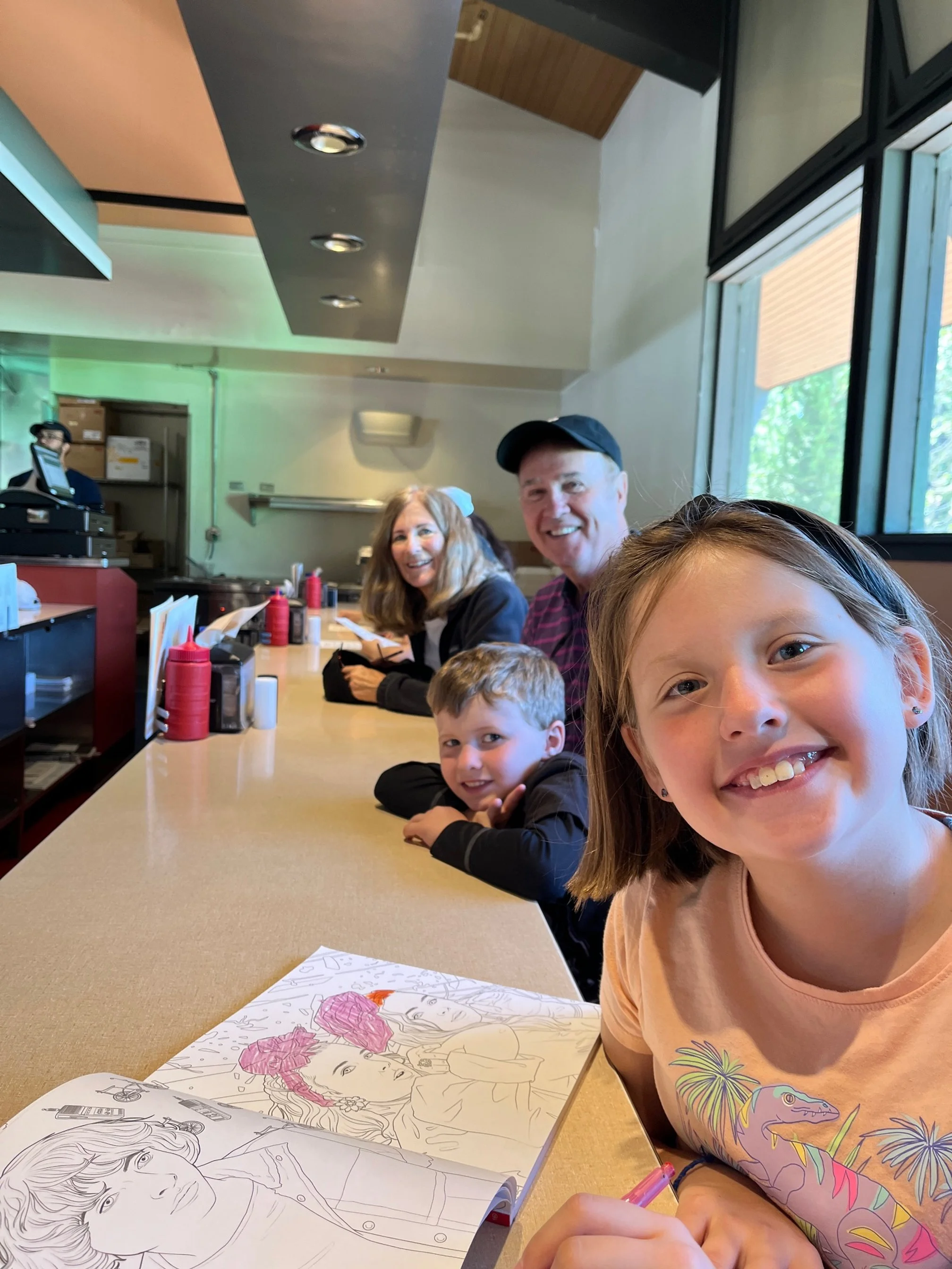 The author's children and parents sit at the lunch counter at Canyon Fountain and Grill in Yellowstone