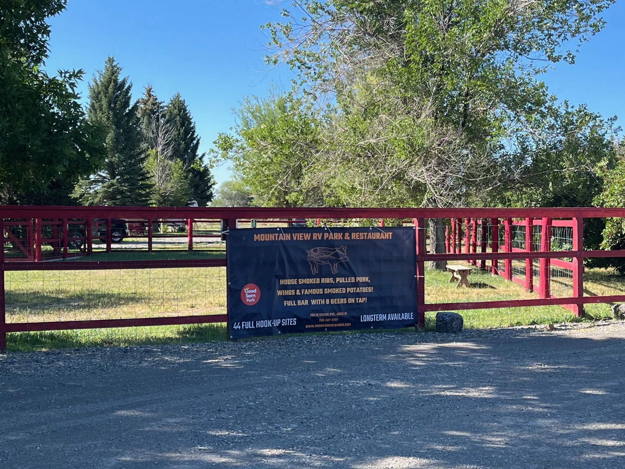 Banner on a red fence advertising the RV park and restaurant