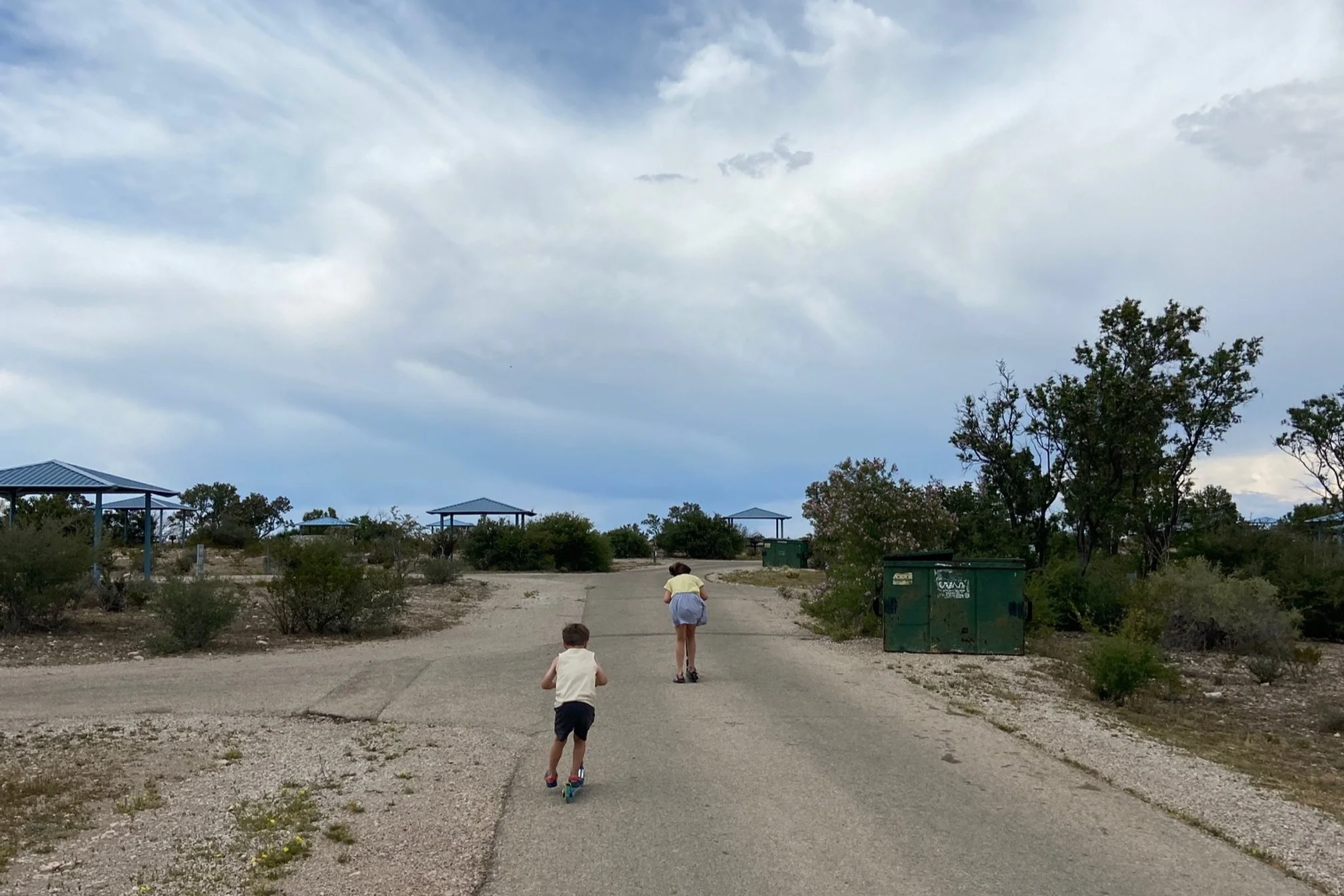 The author's children ride their scooters on the campground loop road