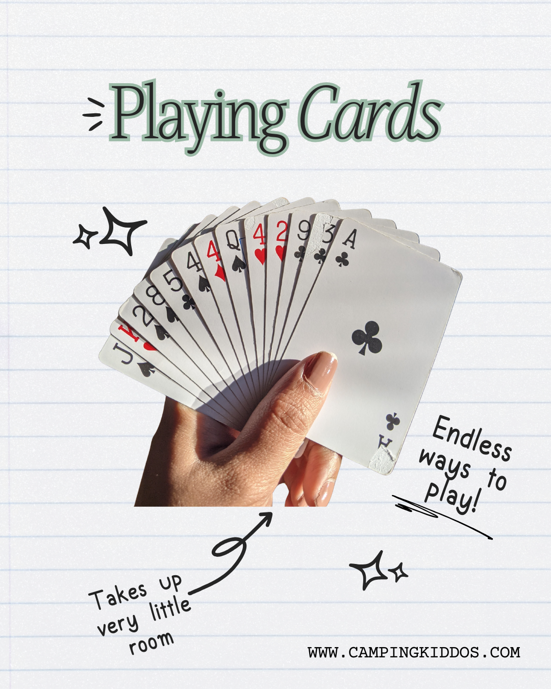 a woman's hand holds a fan of playing cards