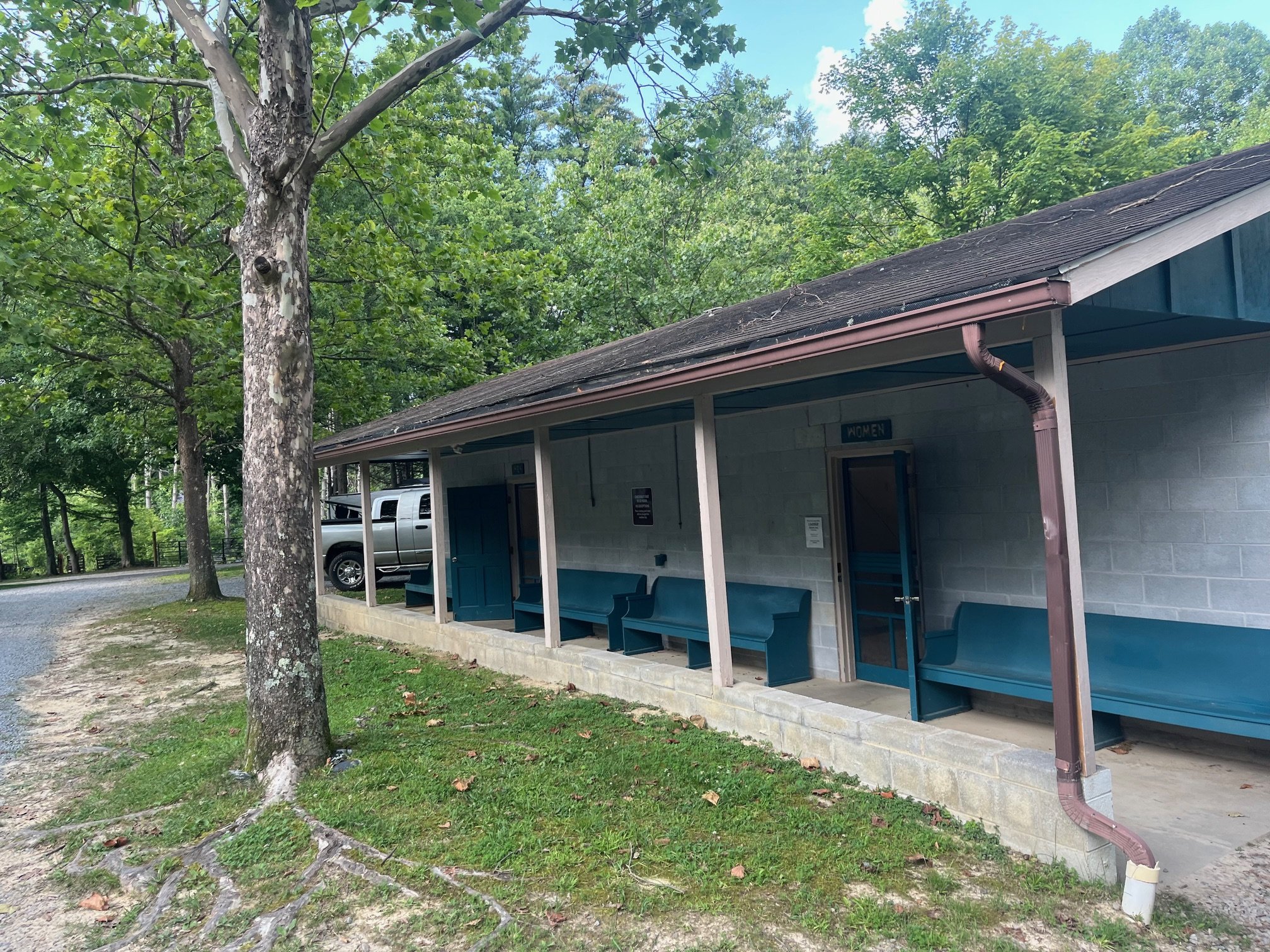 Campground bath house with blue benches out front