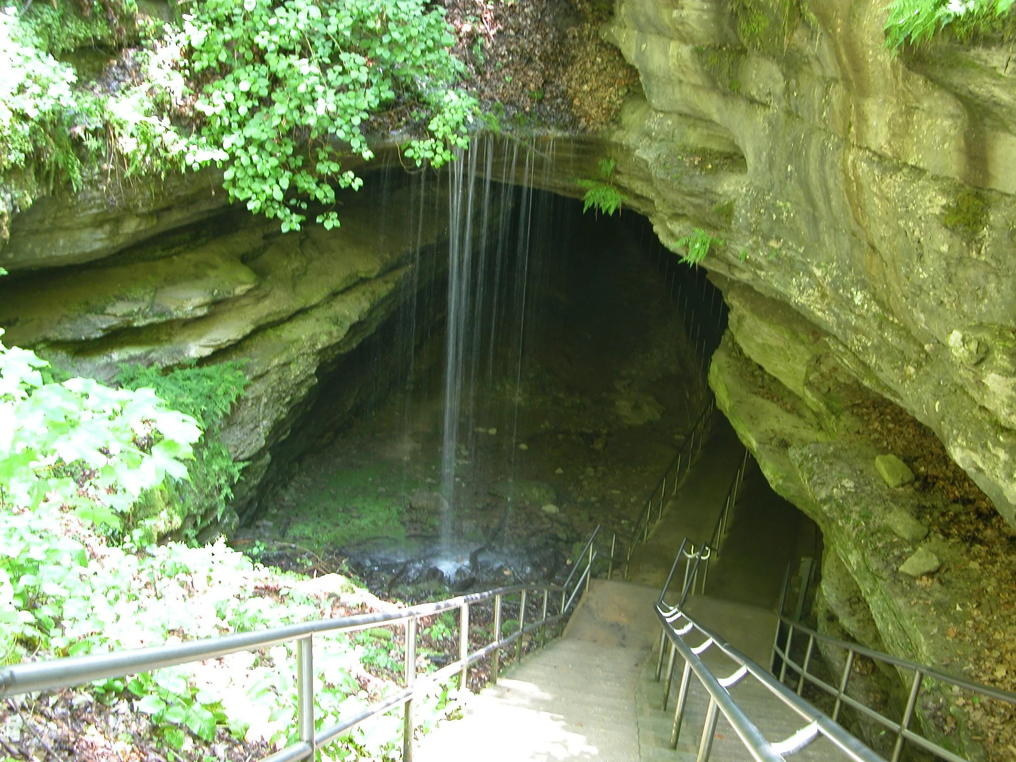Entrance to Mammoth Cave National Park via a staircase with a small waterfall nearby