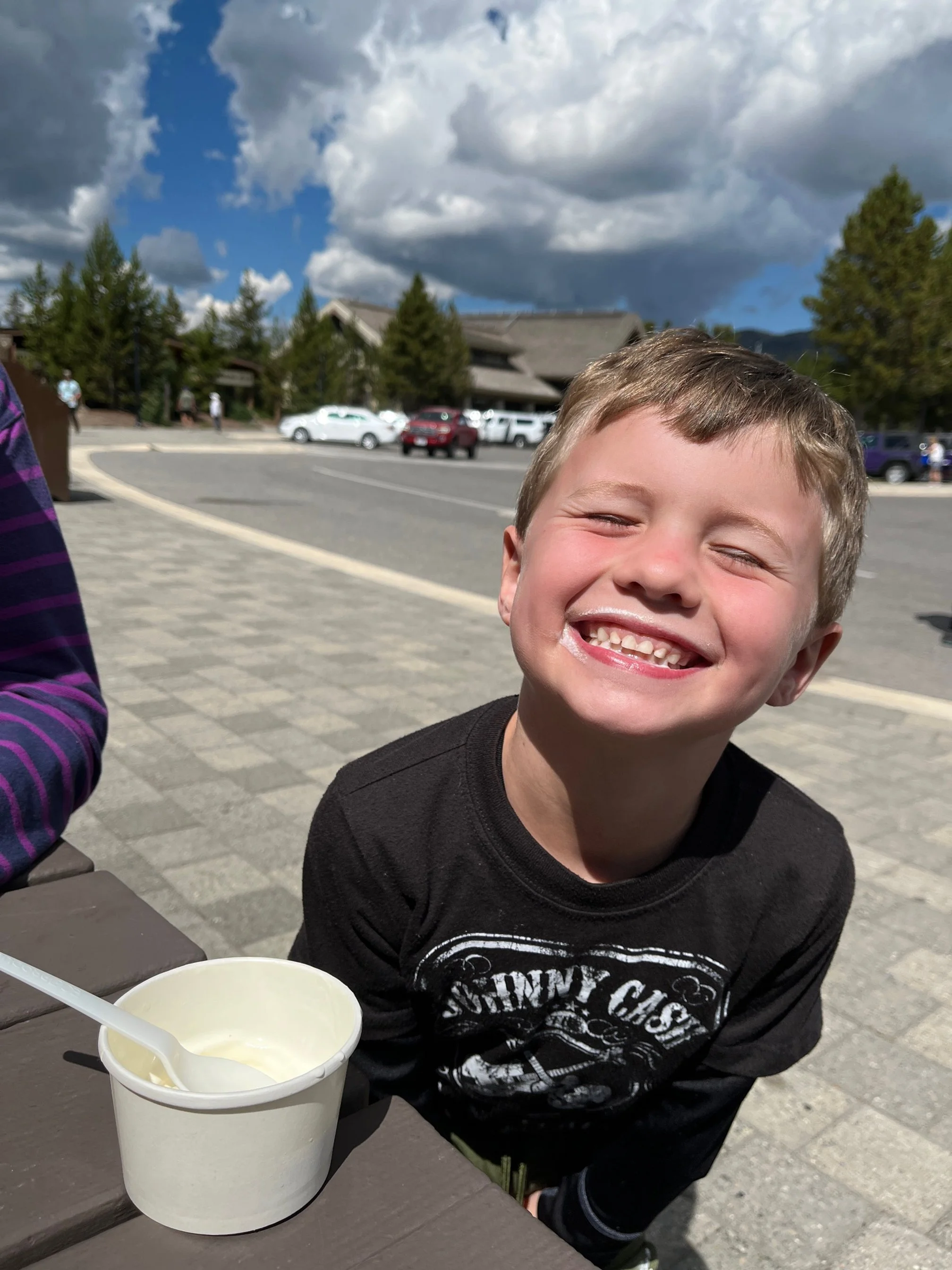 The author's young son smiles as he eats ice cream at Canyon Village