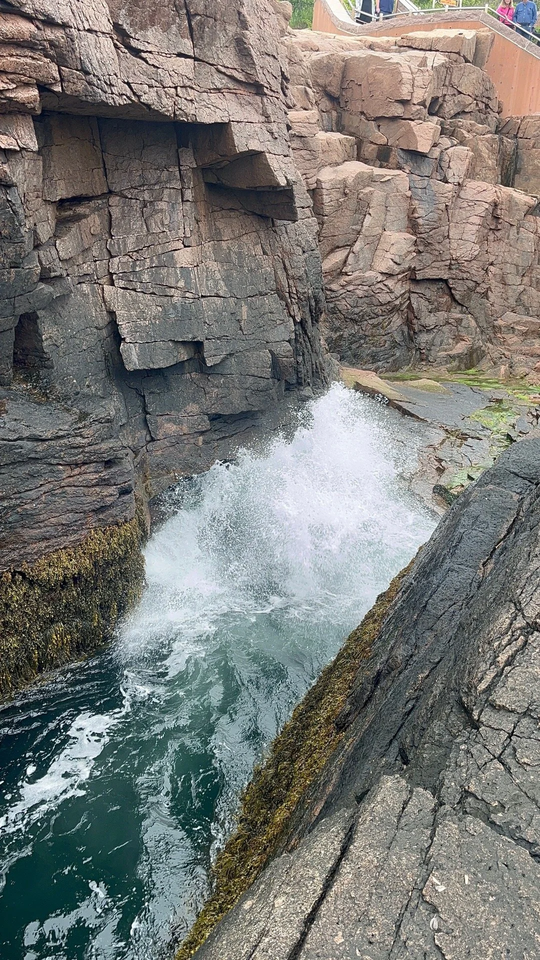 Water rushes into the geological formation on the coast known as Thunder Hole