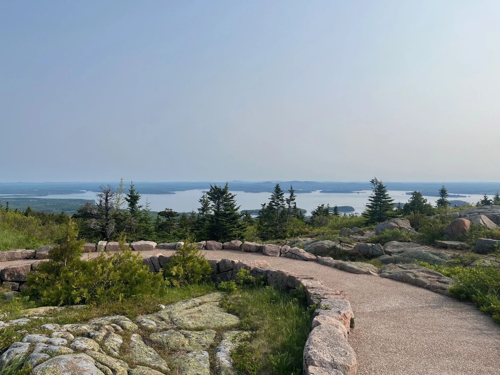 The paved path at the summit of Cadillac Mountain looking back towards Bar Harbor