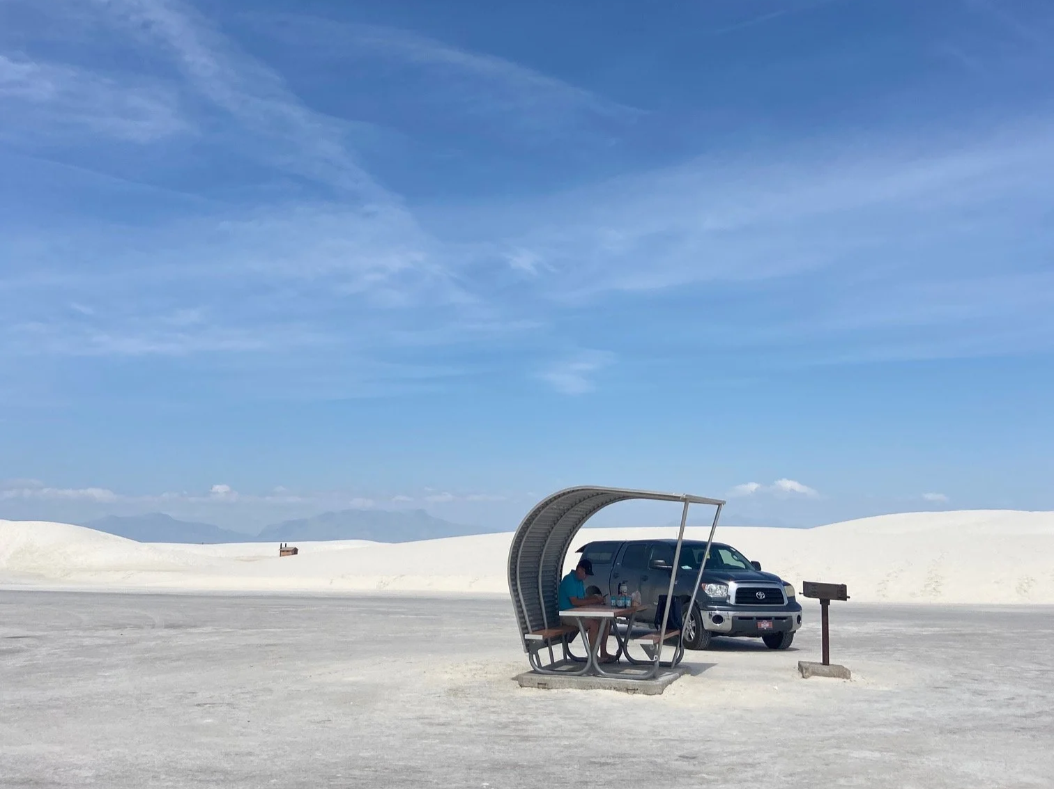 The metal covered picnic table at White Sands is next to the author's blue truck and gill.