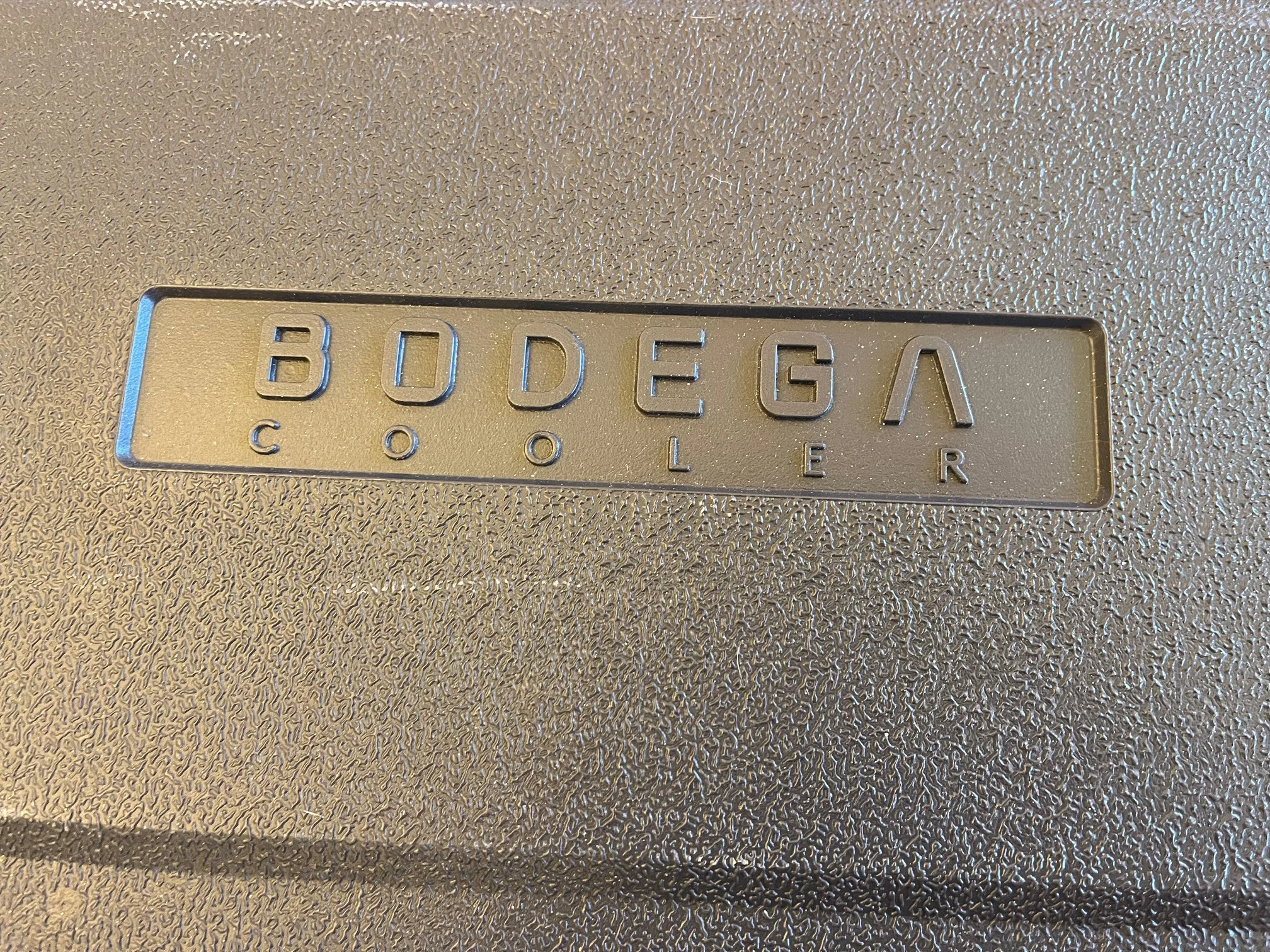 Embossed Bodega cooler logo on the top of the author's unit
