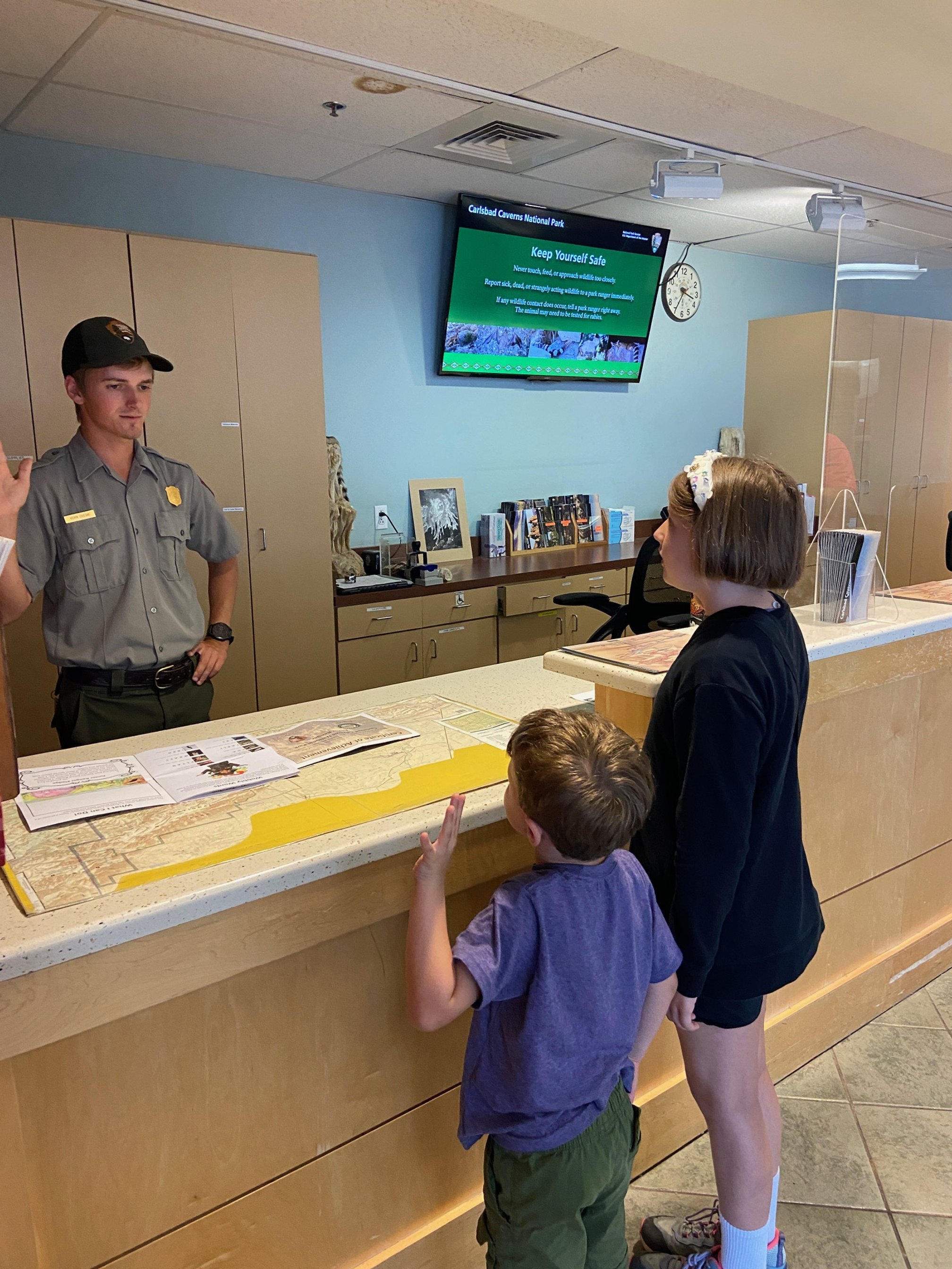 The author's children get sworn in by a young ranger at the Carlsbad Caverns information desk