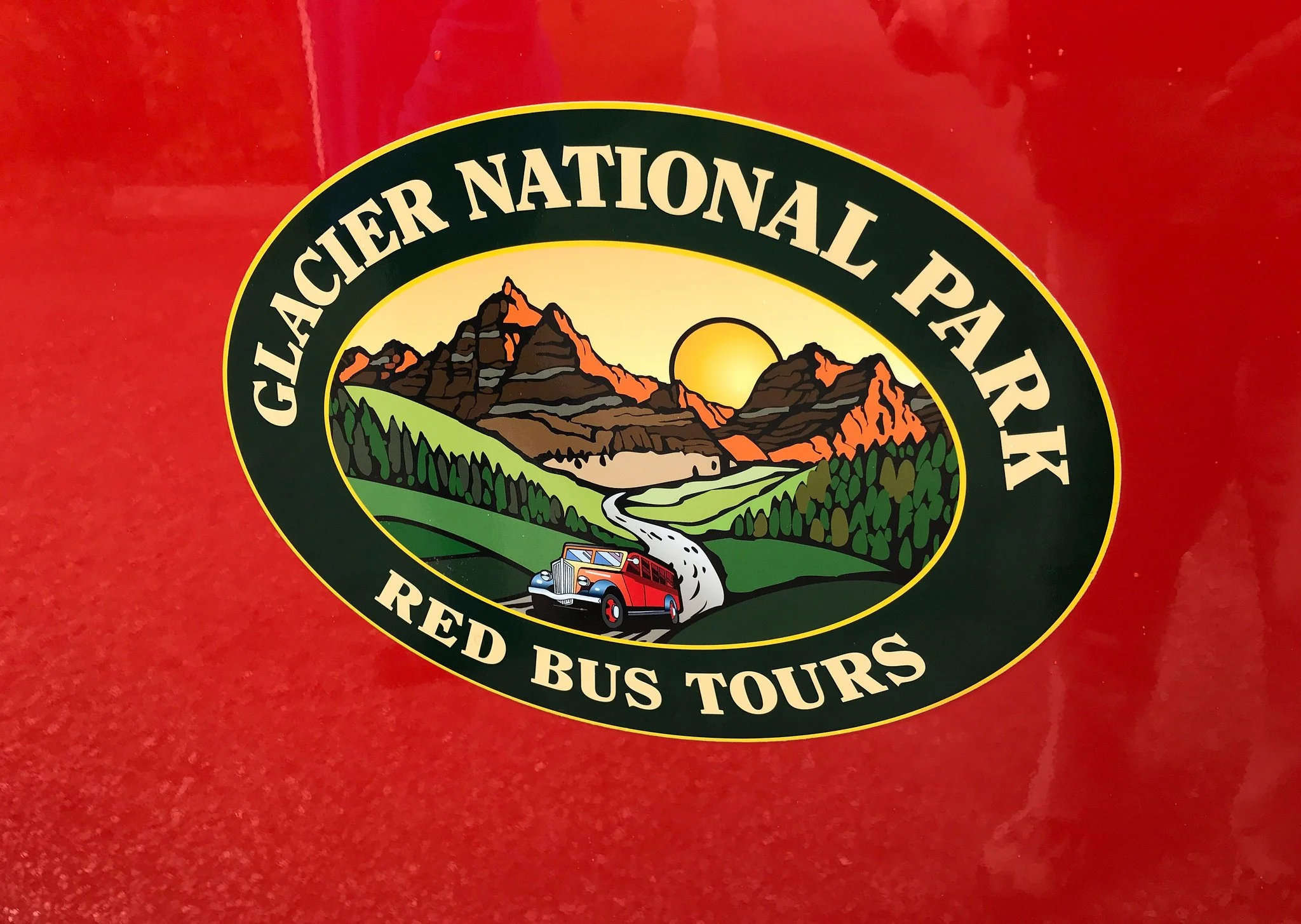 Logo of the Red Bus Tours on the side of the vehicle