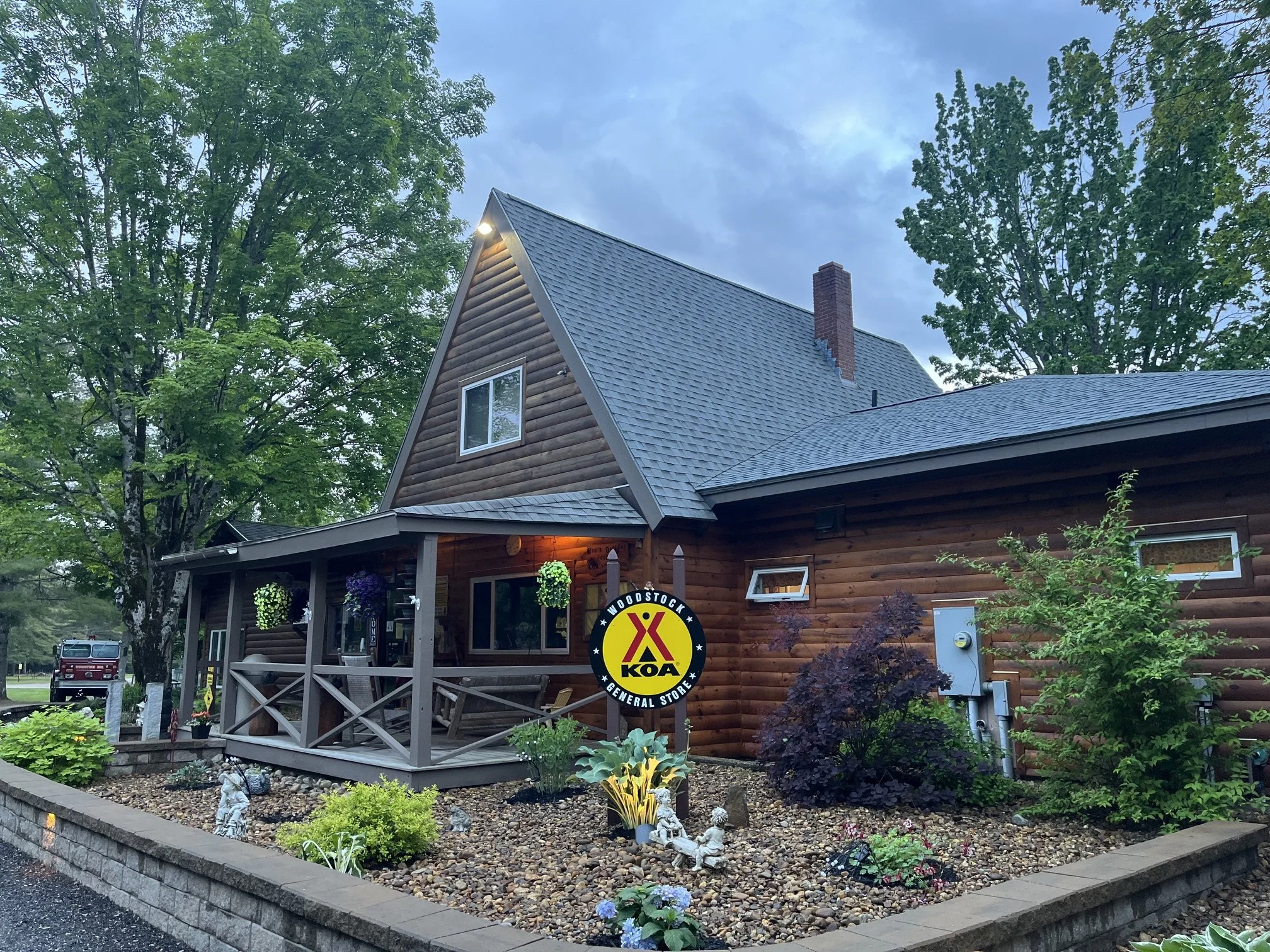 Front office at the Lincoln Woodstock KOA with planters and wooden exterior