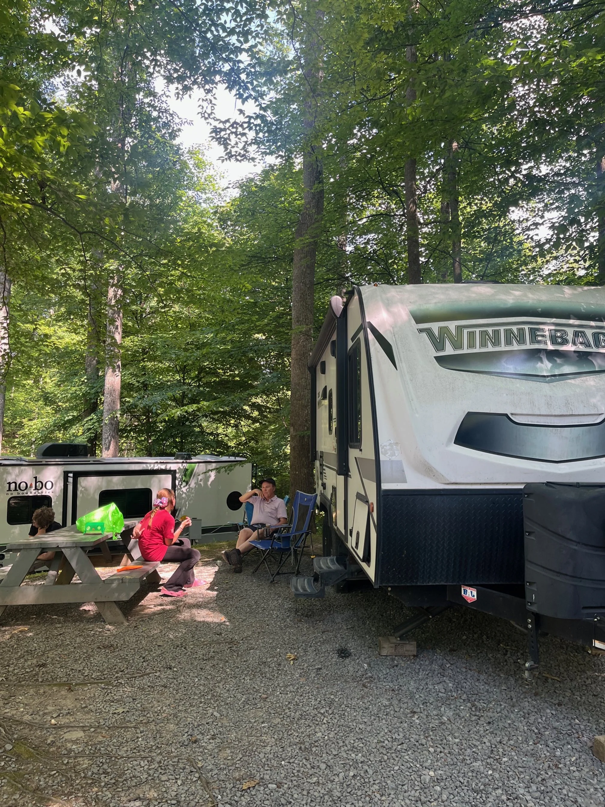 The author's dad and kids hanging out by their camper in site 9 of Rifrafters Campground