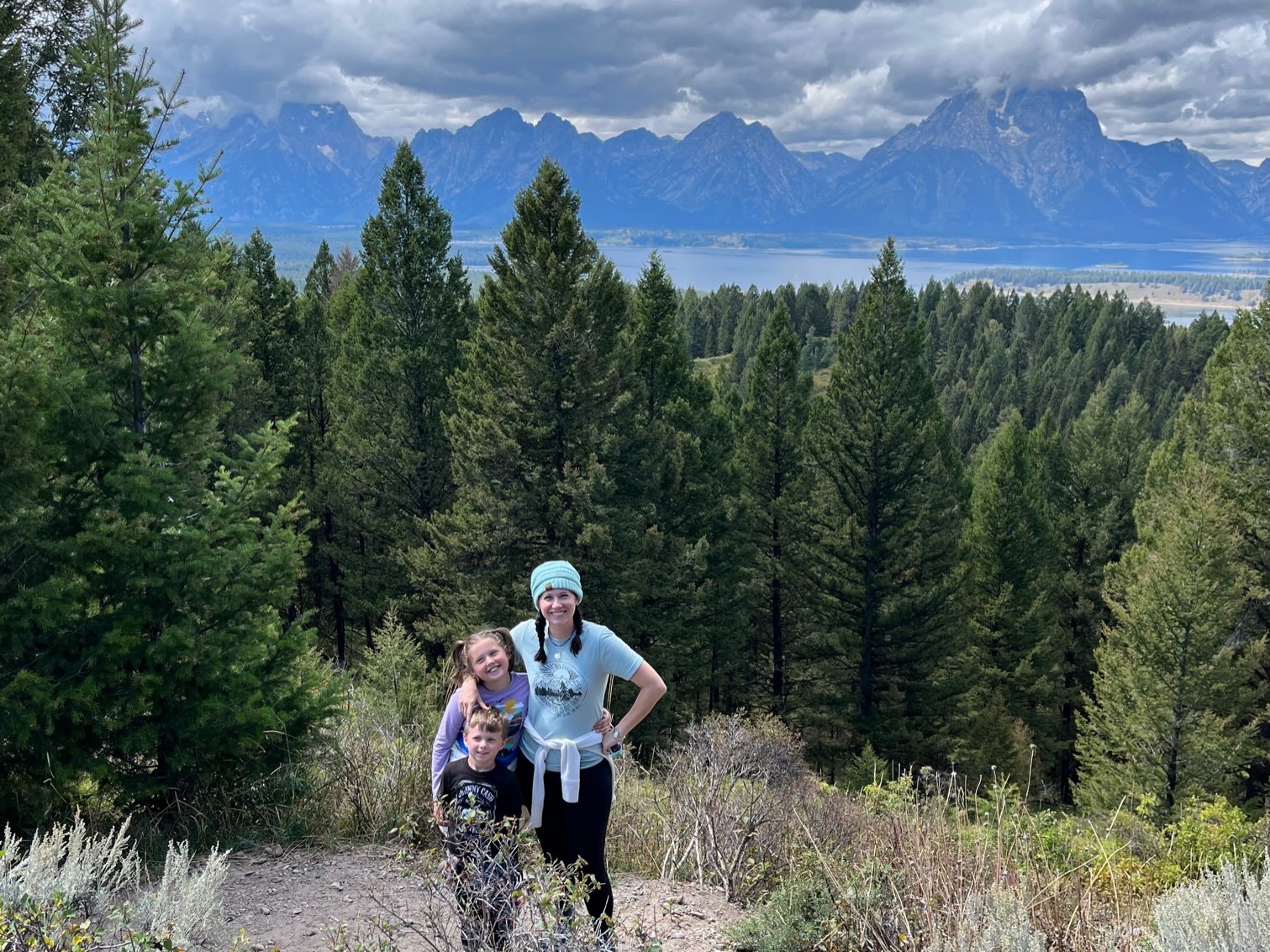 The author and her kids with the Grand Teton mountains and Jackson Lake in the background