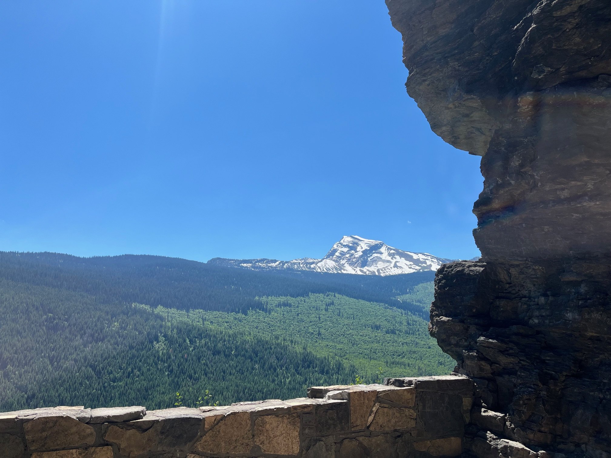 The snow covered Heavens Peak from the overlook