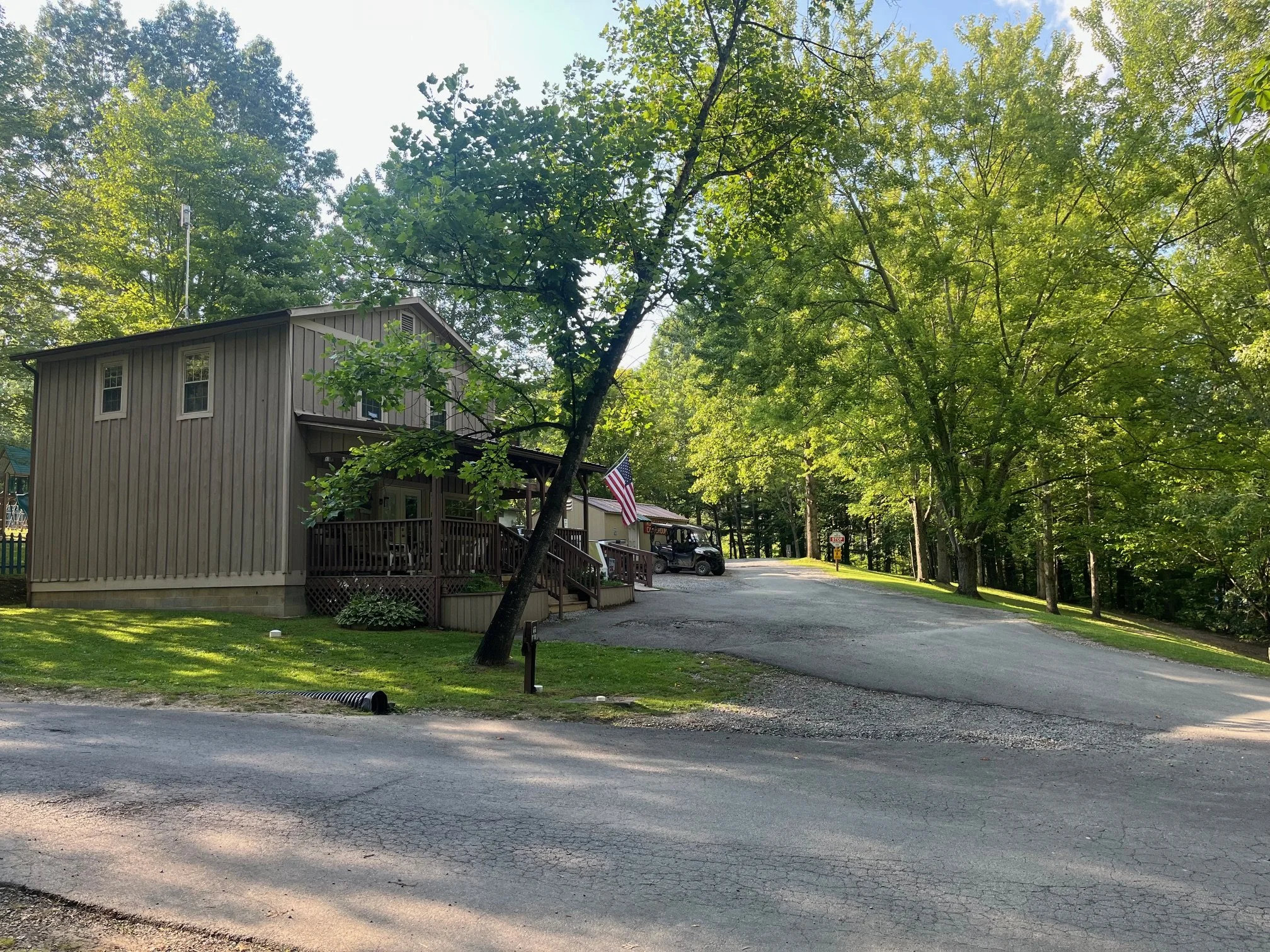 beige wooden front office building with American flag out front