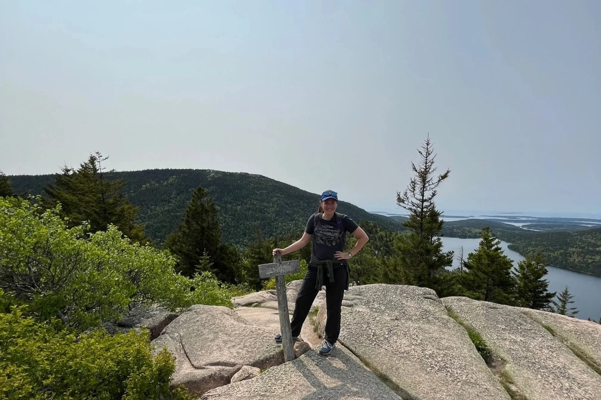 The author standing at the summit sign on North Bubble Trail