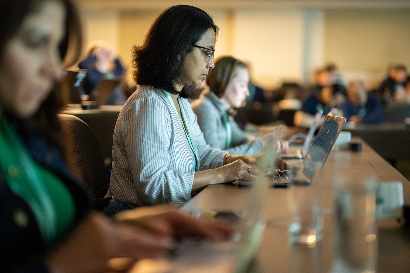 ocused attendees using laptops during a professional data science workshop in Austin, captured by a corporate event photographer