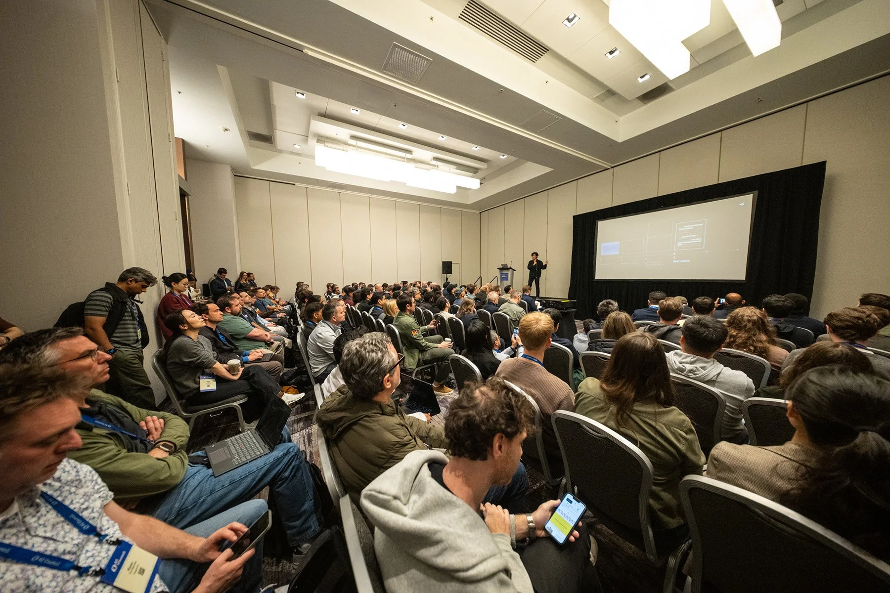 Conference attendee listening to a presentation during the AI Council conference in San Francisco.