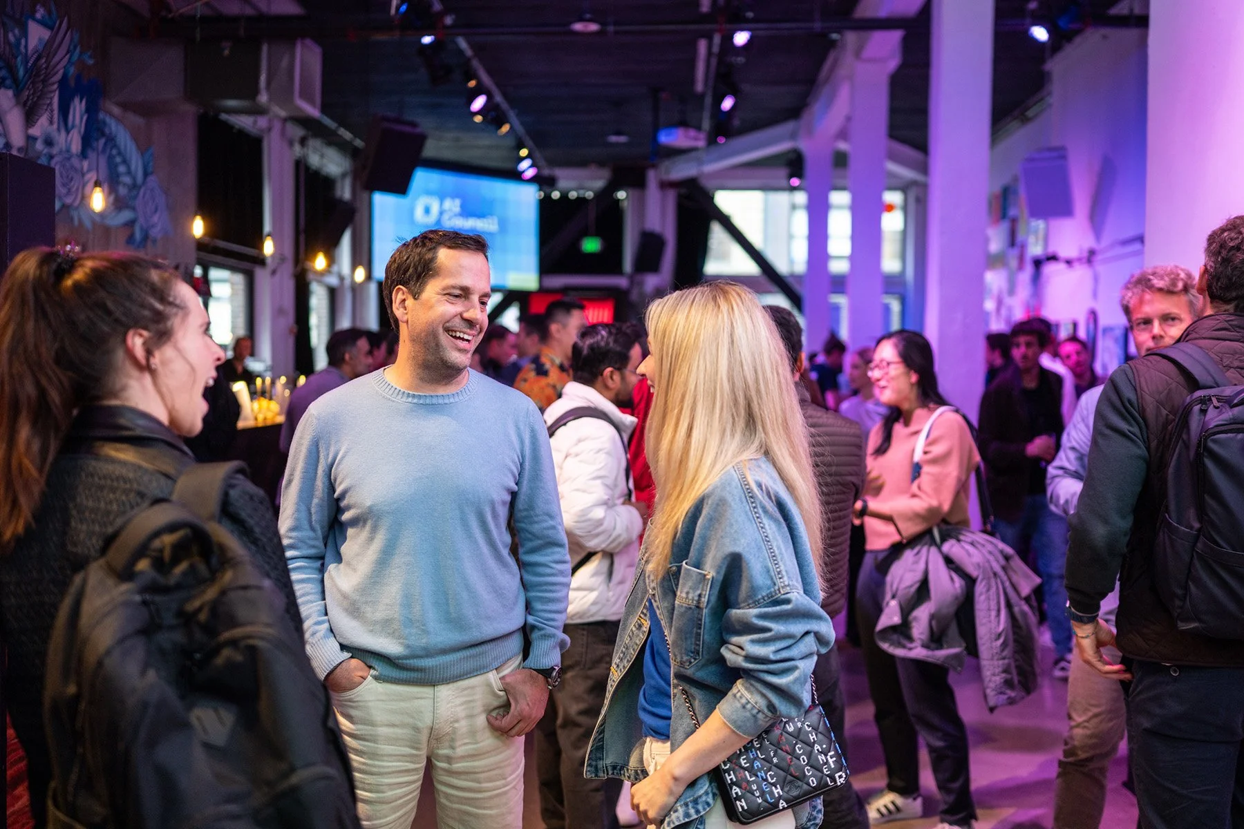 Attendees networking in a happy hour during the AI Council