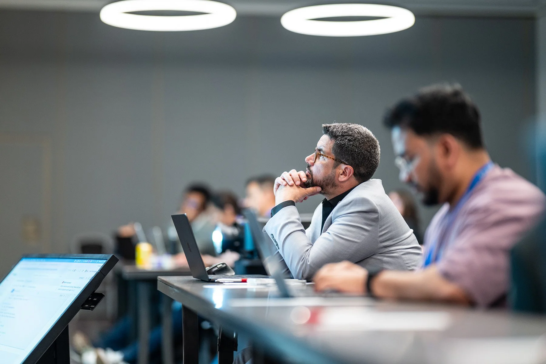 Conference attendee listening to a presentation during the AI Council conference in San Francisco.