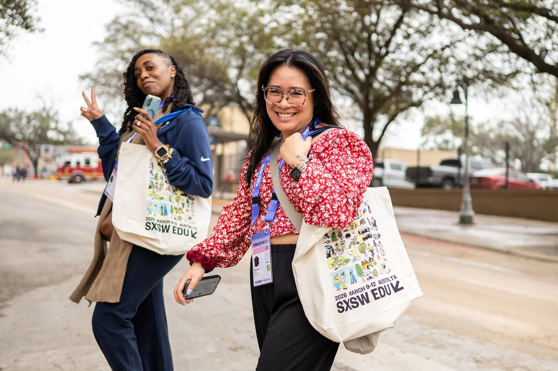 SXSW EDU 2026 attendees display official canvas tote bags in Austin. Candid street portrait by Tico Mendoza Studios highlights event branding and attendee enthusiasm.
