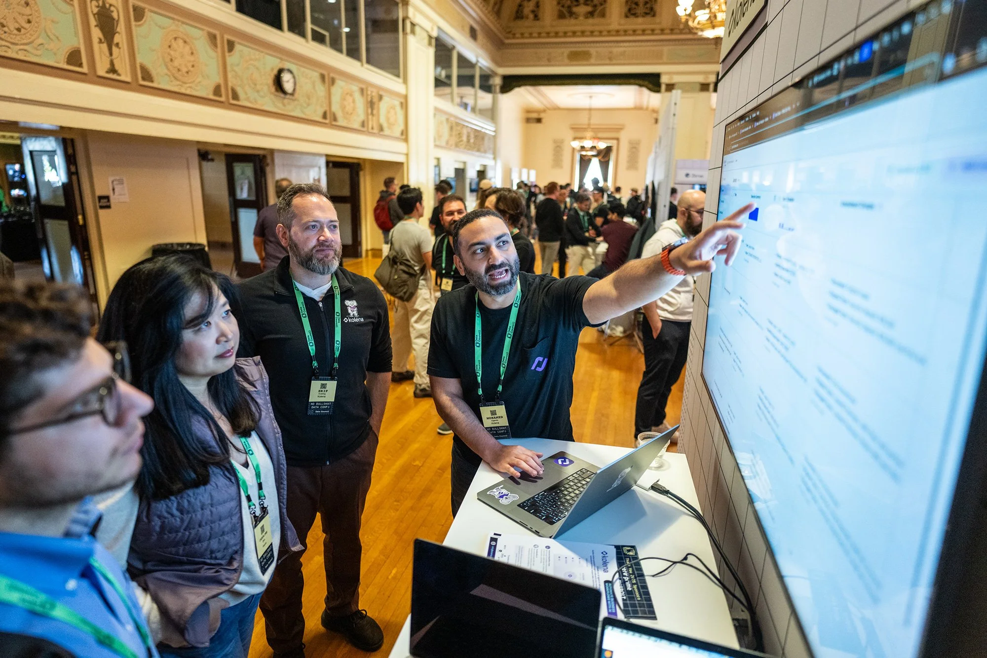 A group of attendees at the Data Council conference engaged in a software demonstration, captured by a professional Austin corporate event photographer.