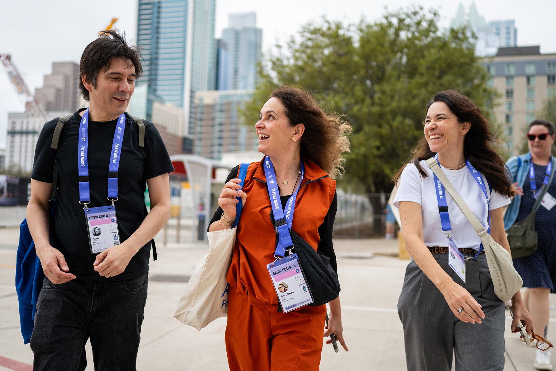 Attendees walking in downtown smiling and looking to each other