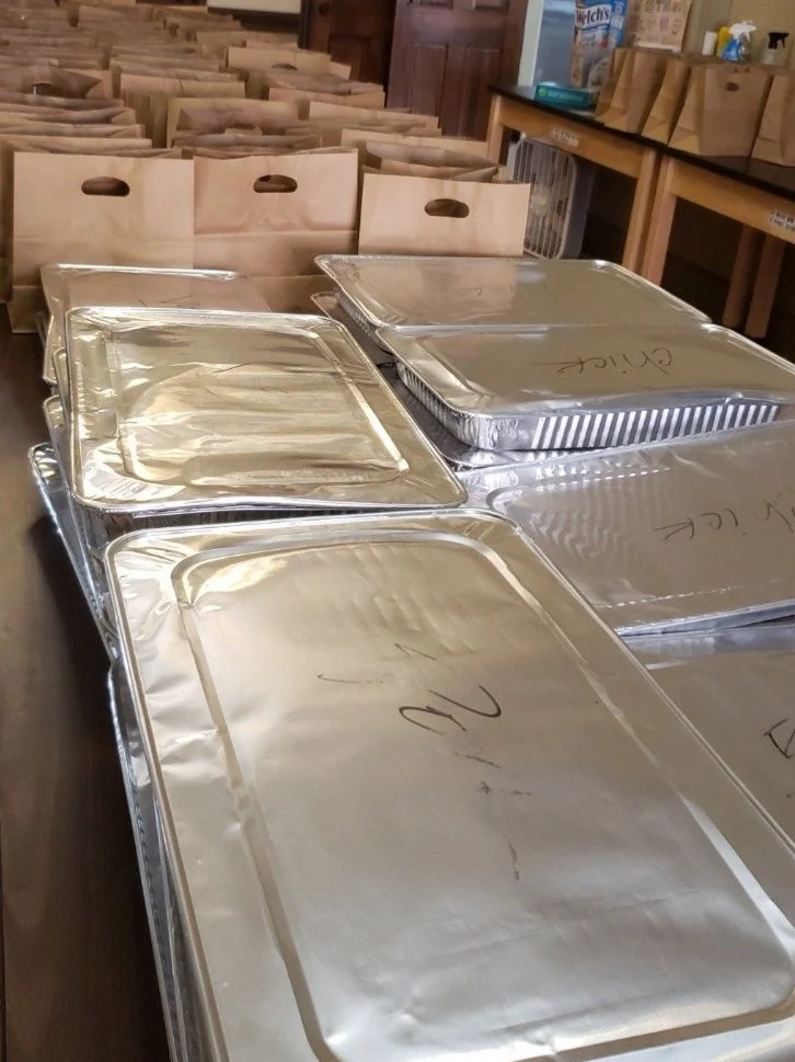 Serving hot meals and groceries from Whole Foods donations