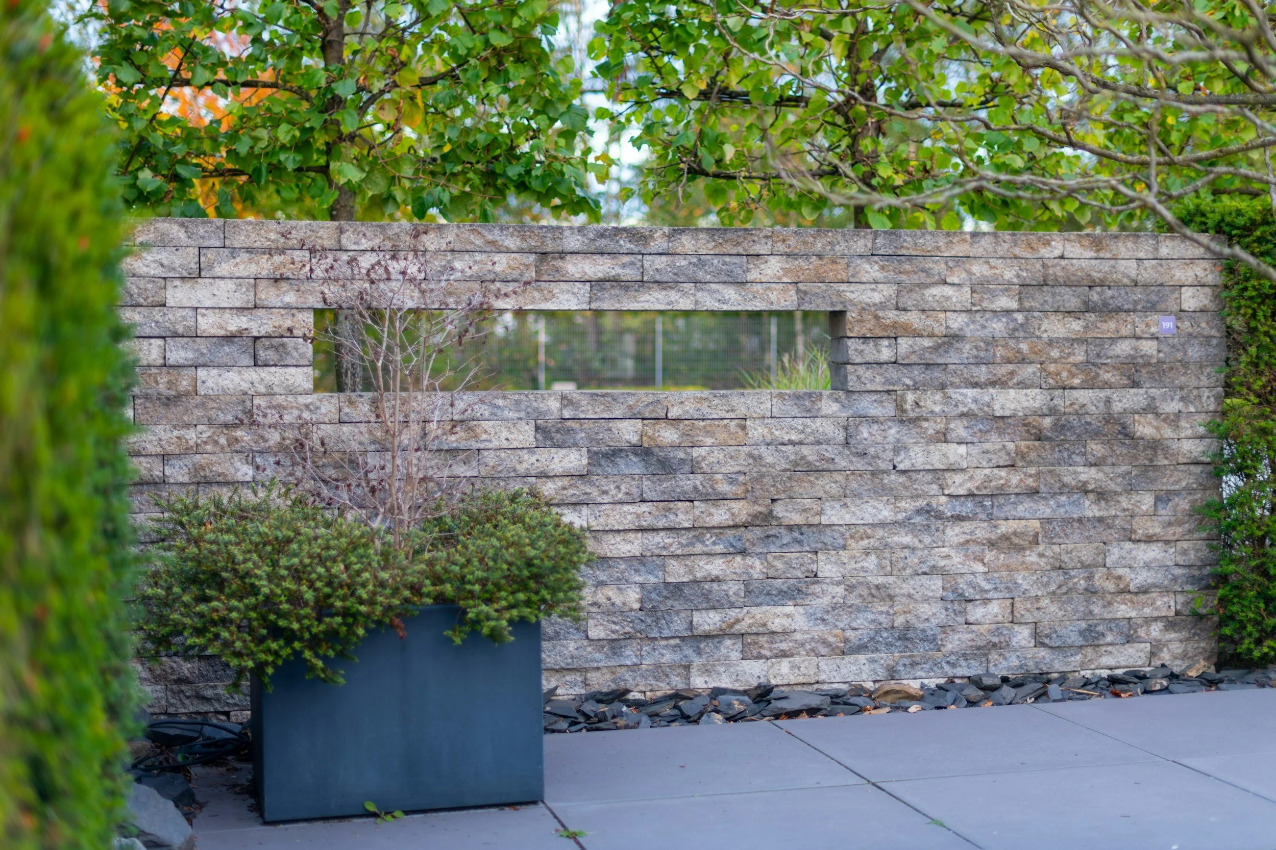 Close up of concrete walkway with a complementing retaining wall