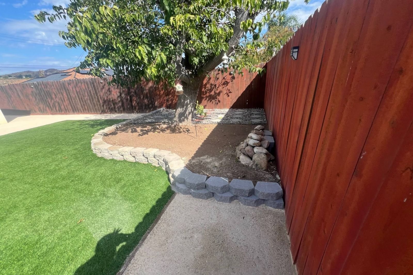 Backyard landscaping refresh in Santee, CA showcasing garden wall, decomposed granite, and artificial turf