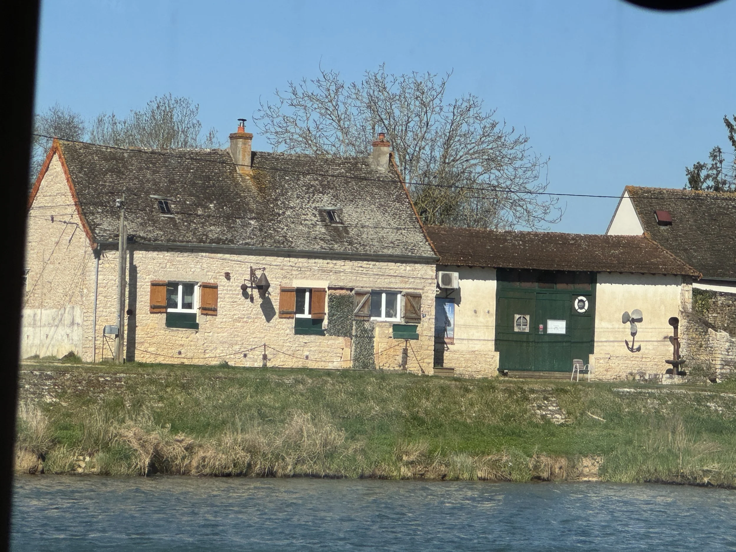   Interesting adornments on the side of this house - an anchor, a boat prop, and some sort of weather gauge???  