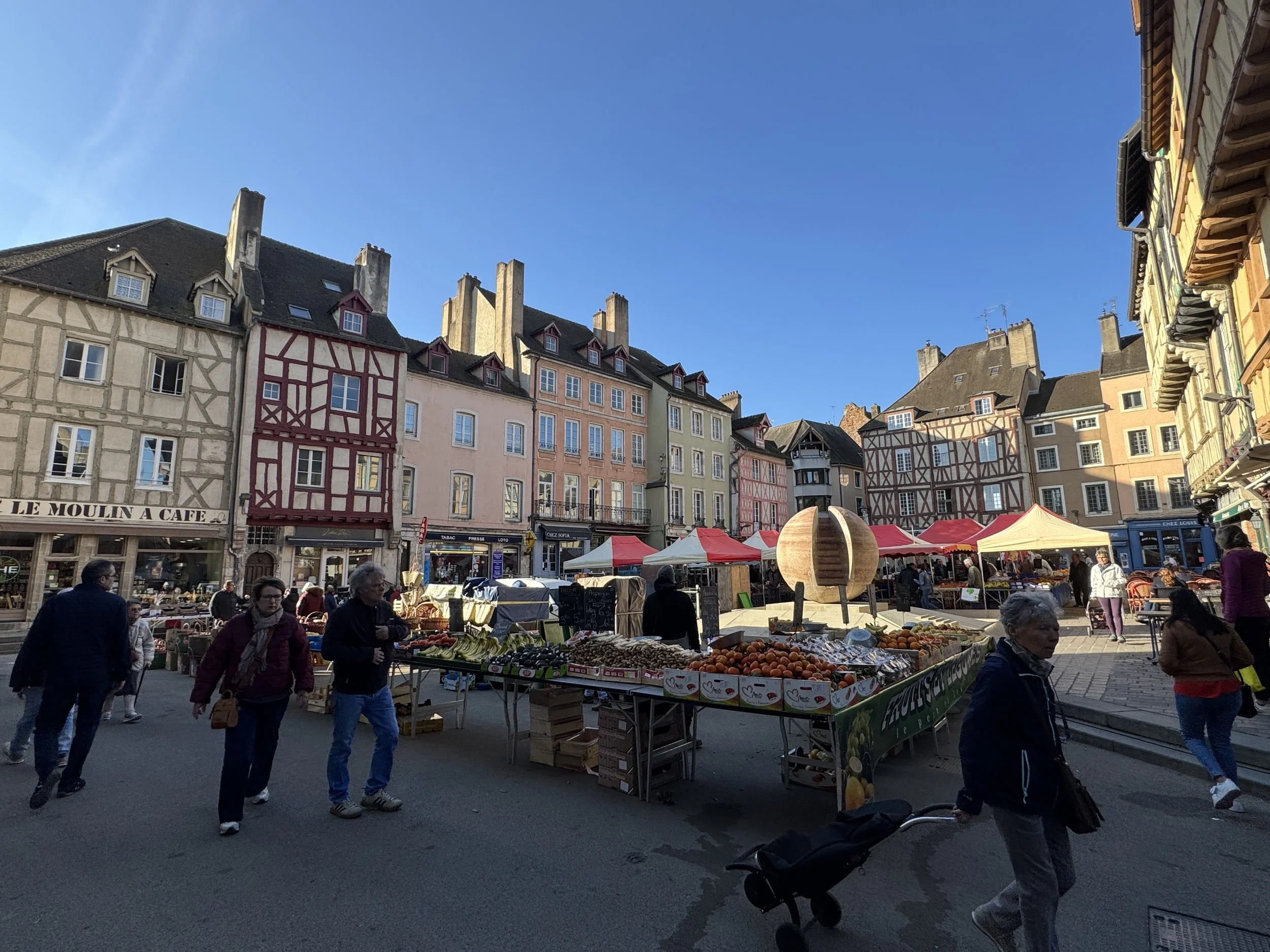  A contemporary spherical sculpture stands in one corner of the square.  