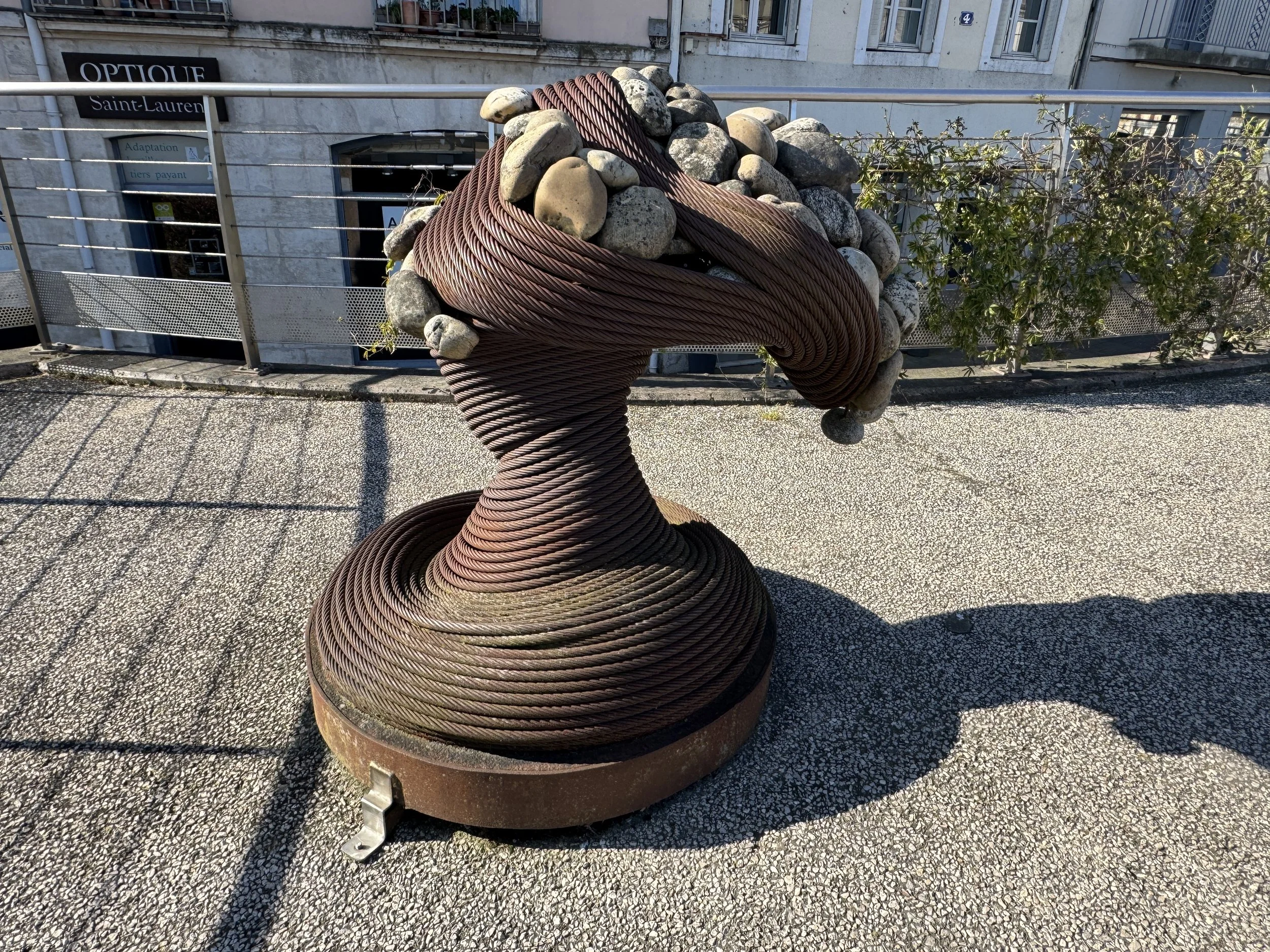   Suspended stones and coiled cable sculpture  