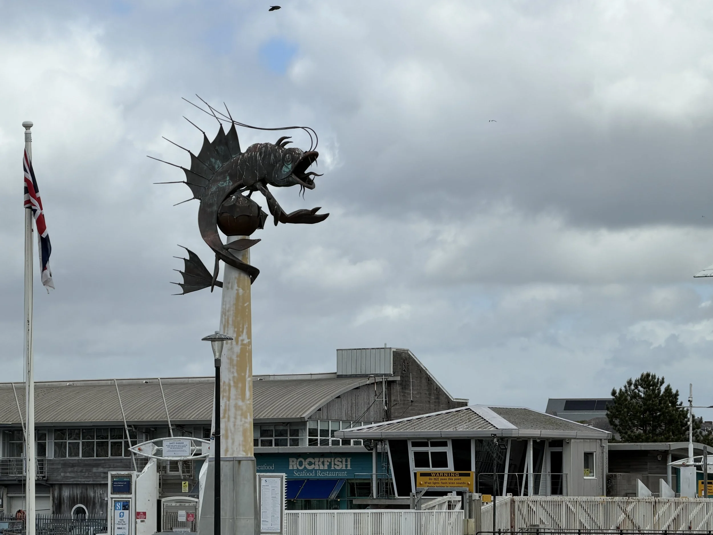   33-foot tall metal sculpture titled "The Leviathan," known locally as the Barbican Prawn. It’s eyes are lit up at night.  