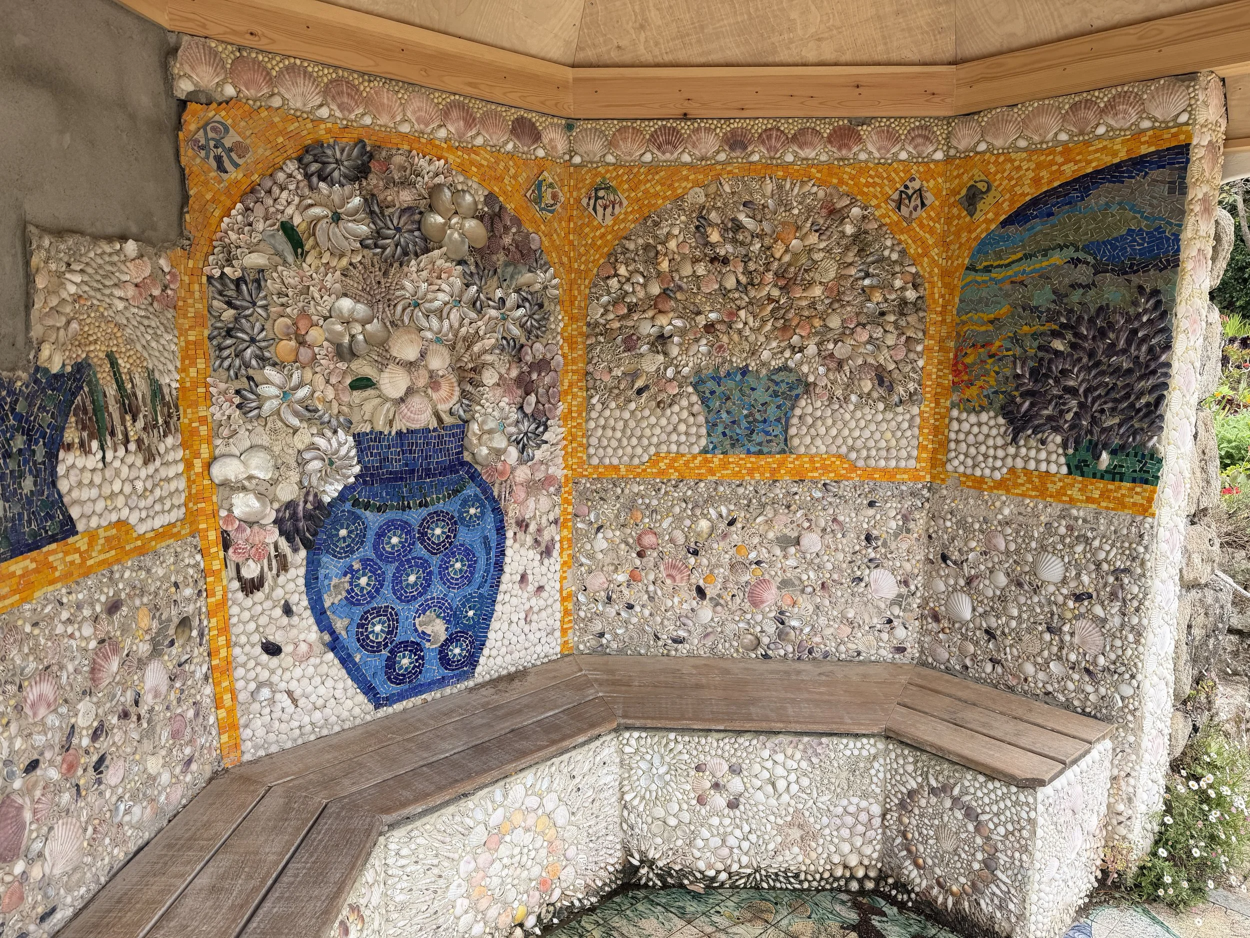   A small hidden gazebo completely decorated with a shell mosaic  